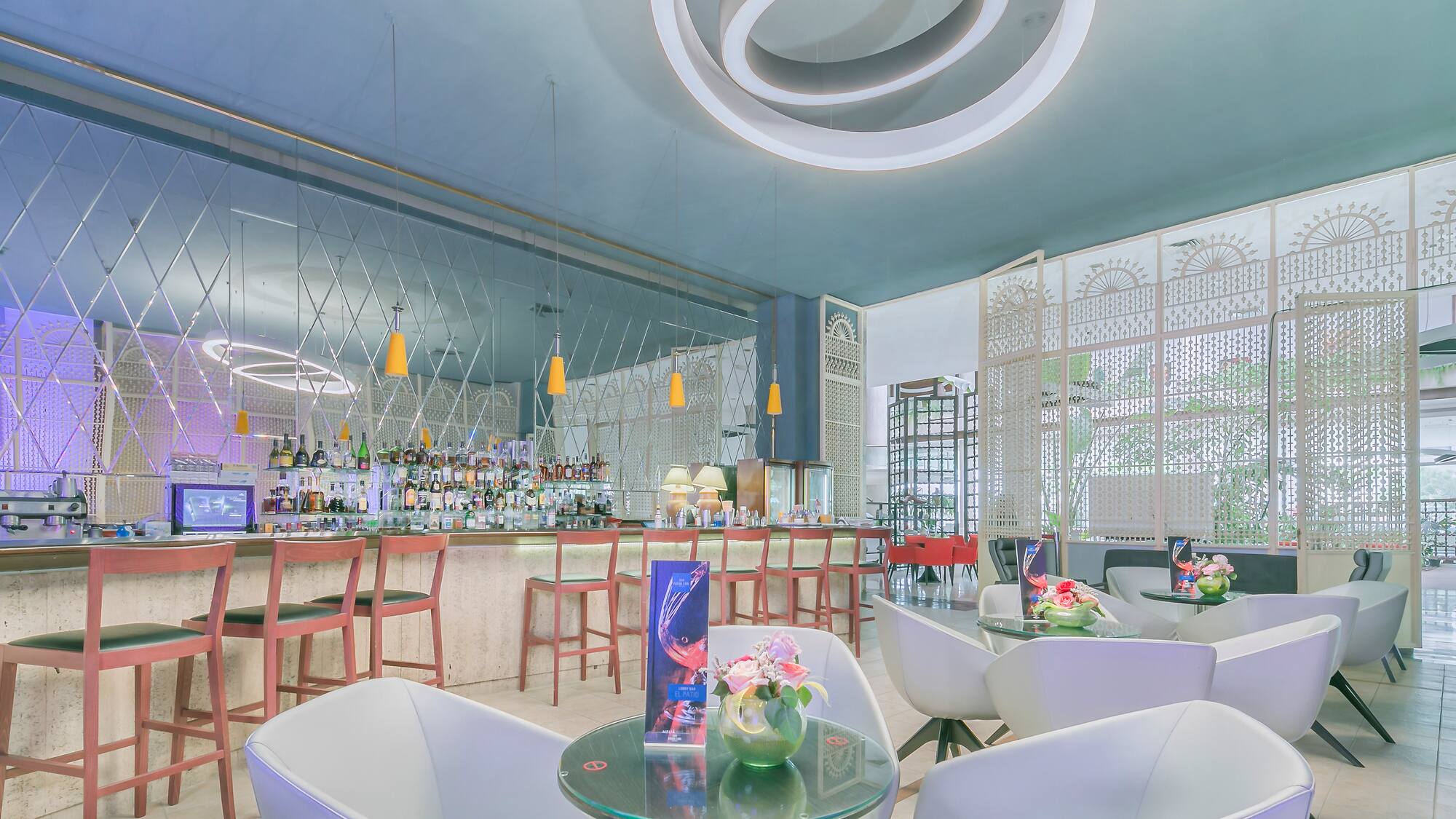 a bar with white chairs and tables