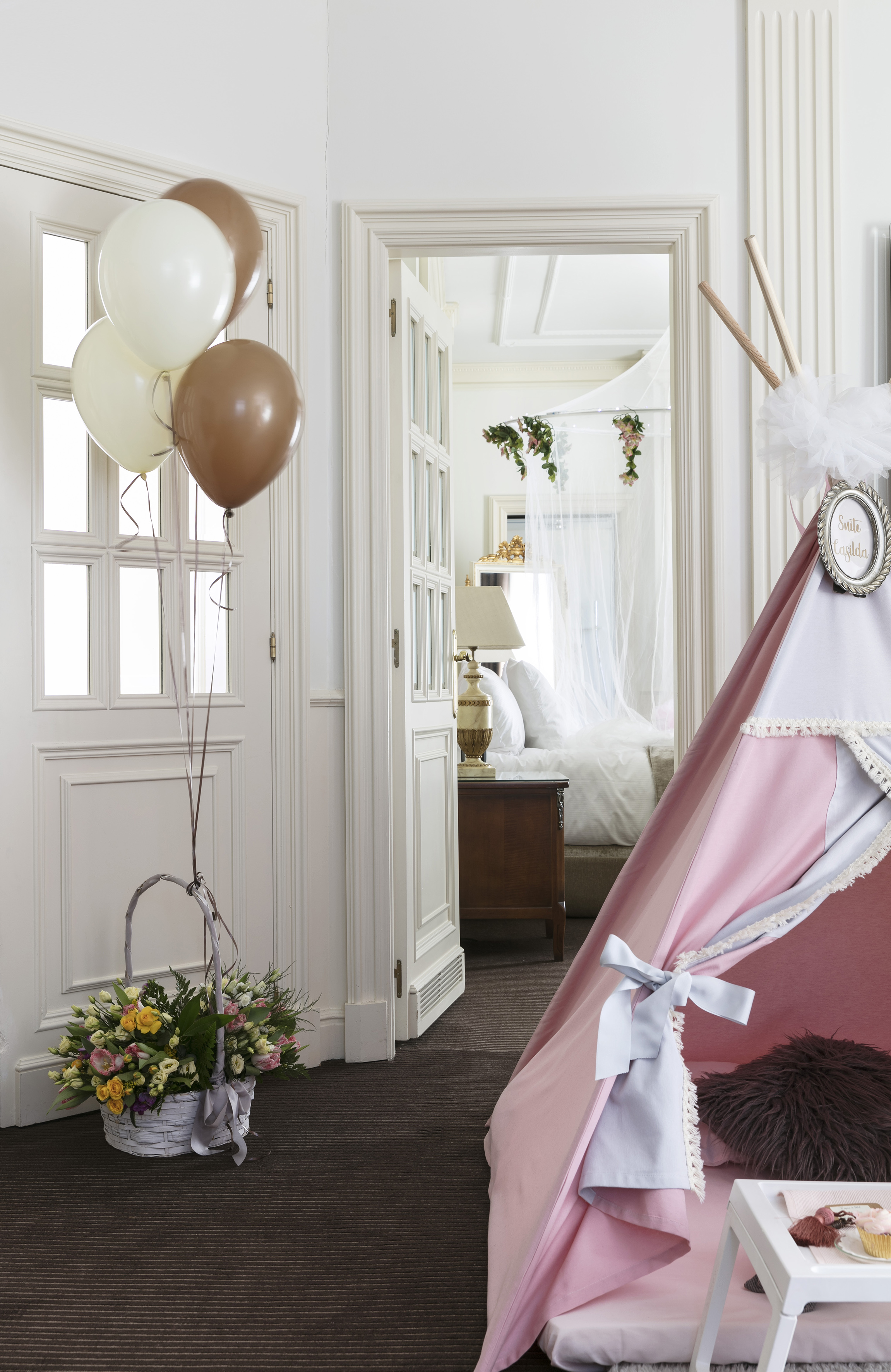 a room with a tent and balloons