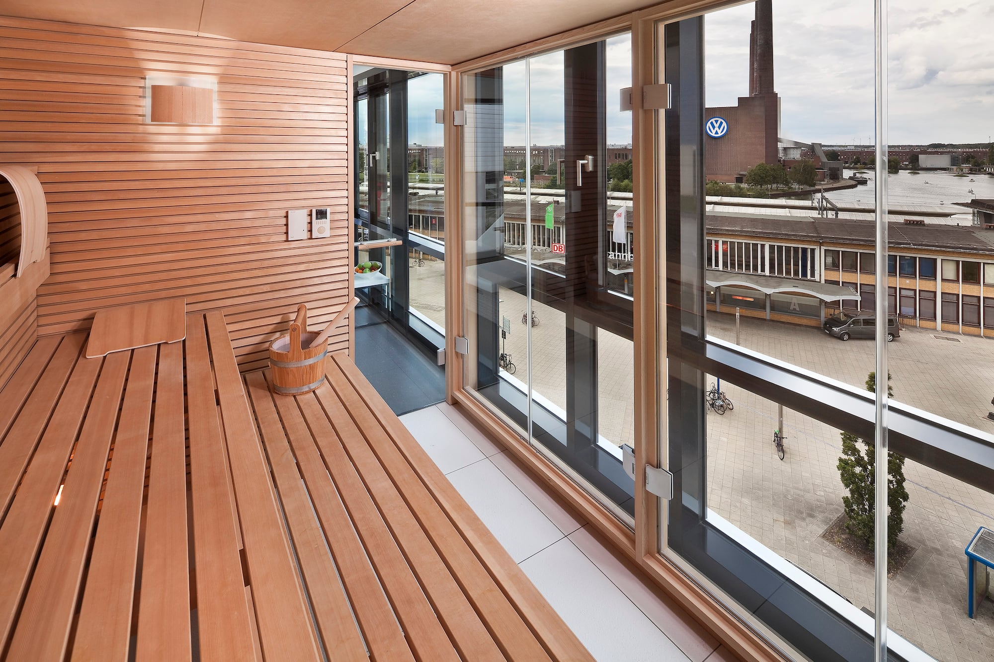 a wooden bench in a room with a view of a city