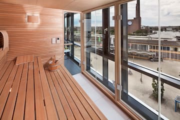 a wooden bench in a room with a view of a city