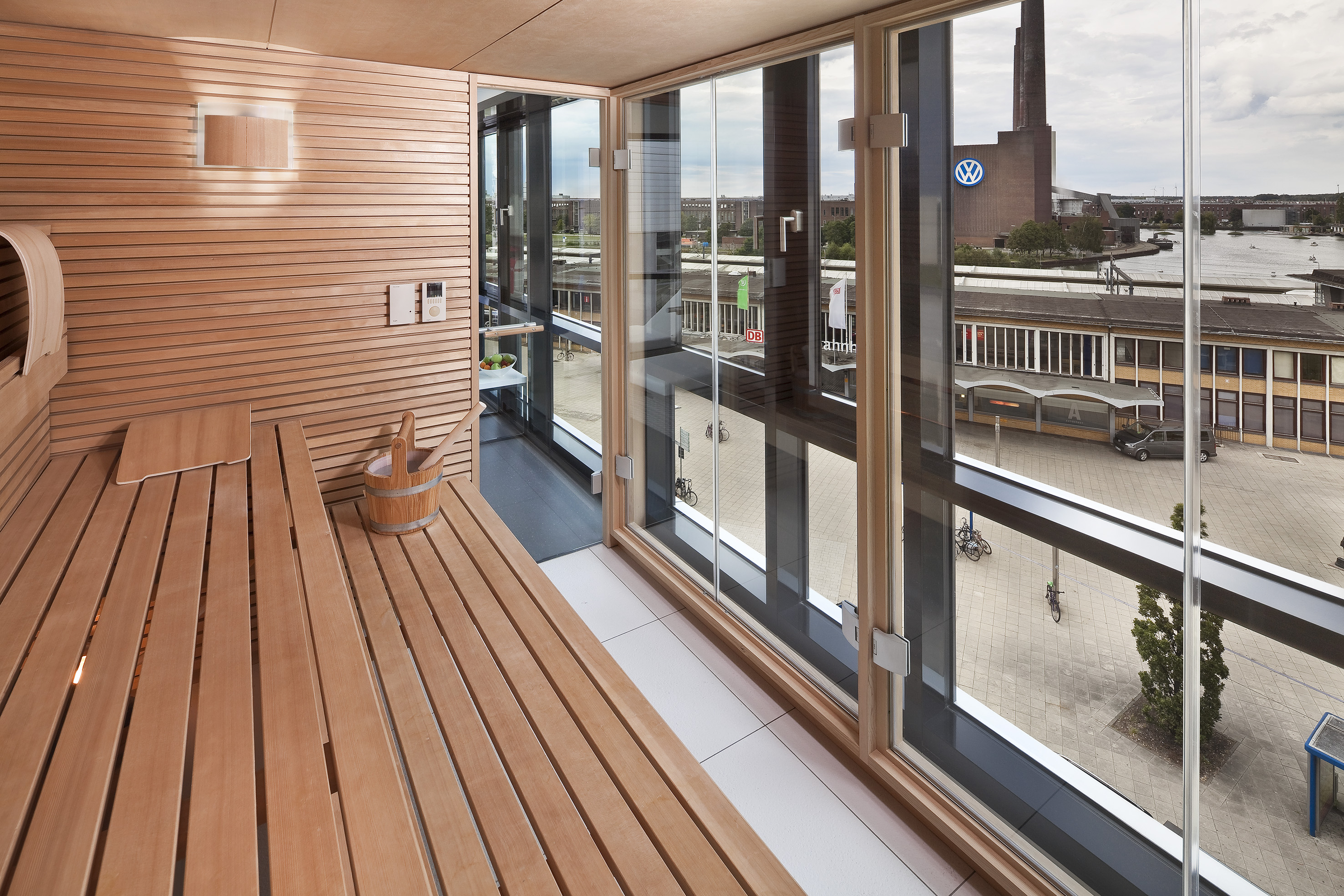 a wooden bench in a room with a view of a city