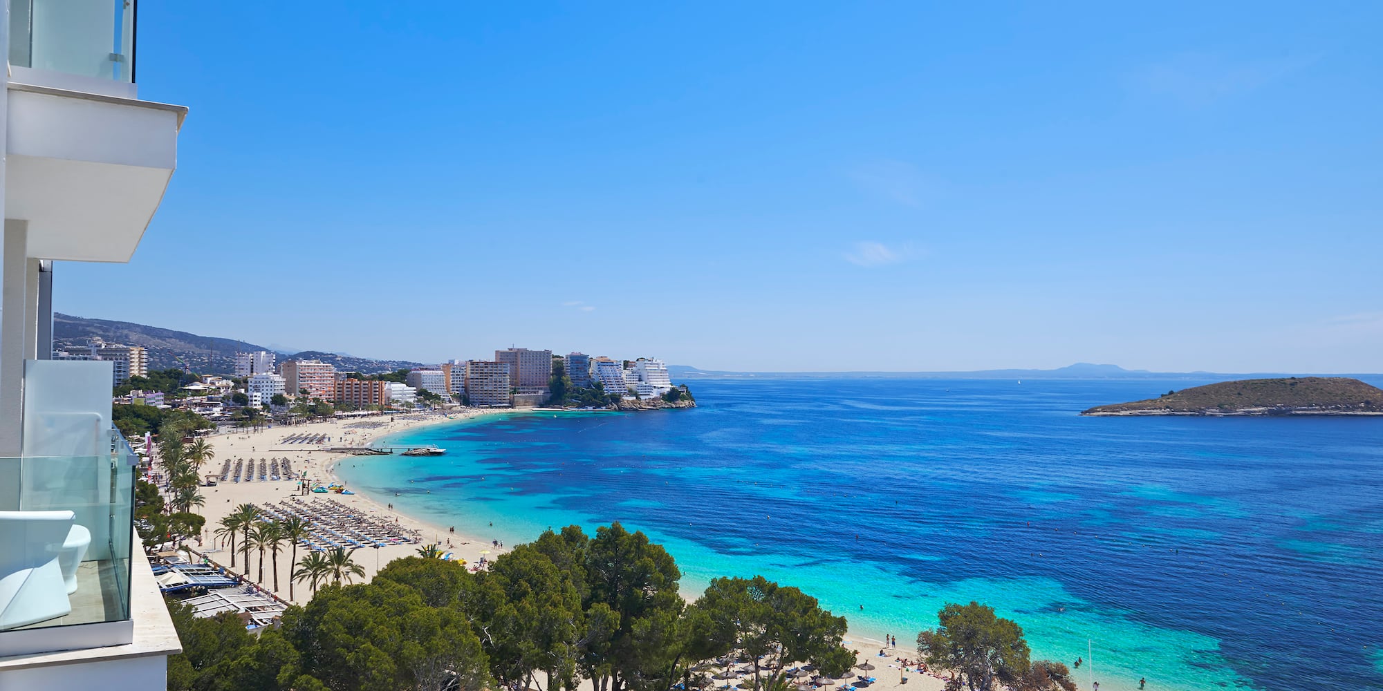 a beach with trees and buildings