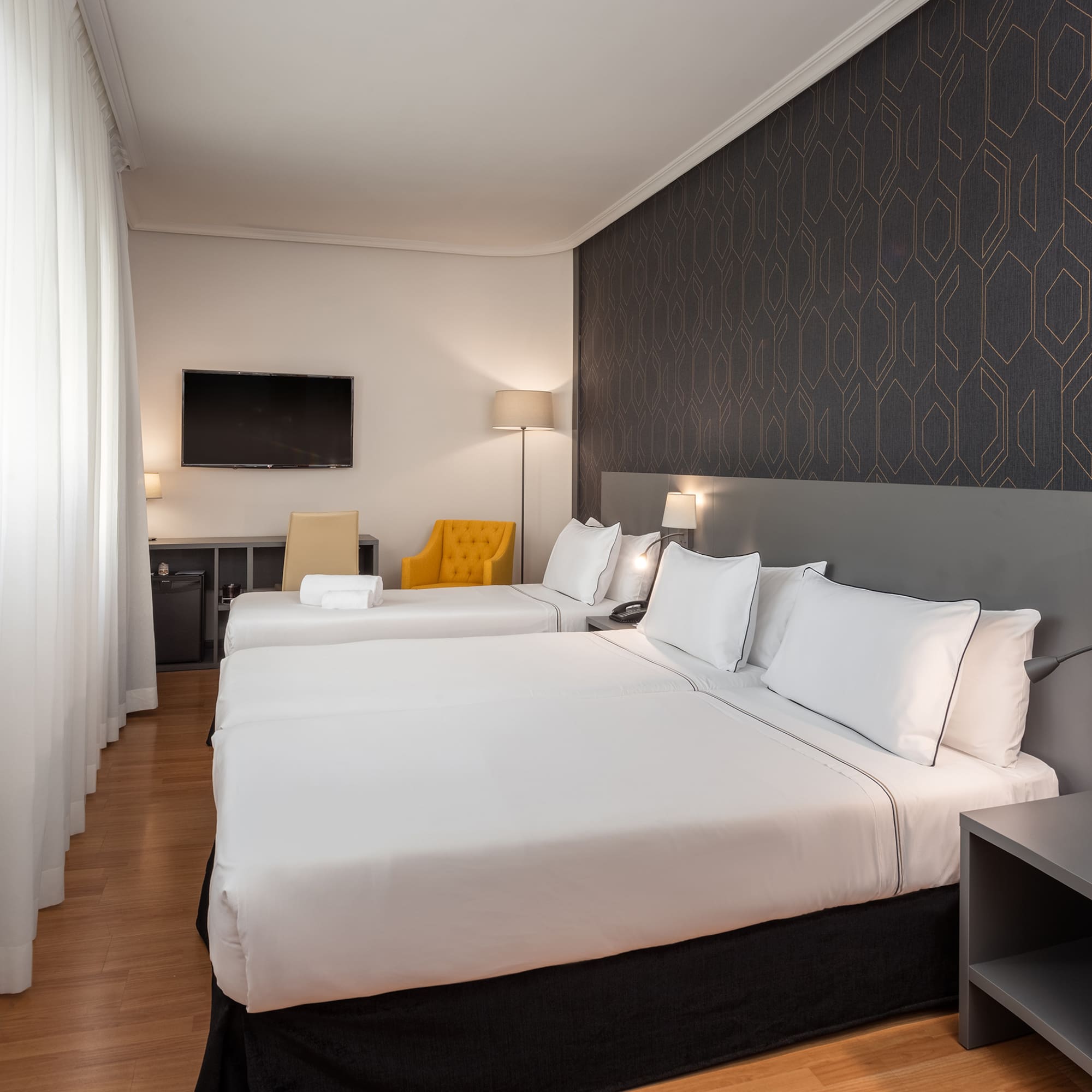 a room with two beds and a tv