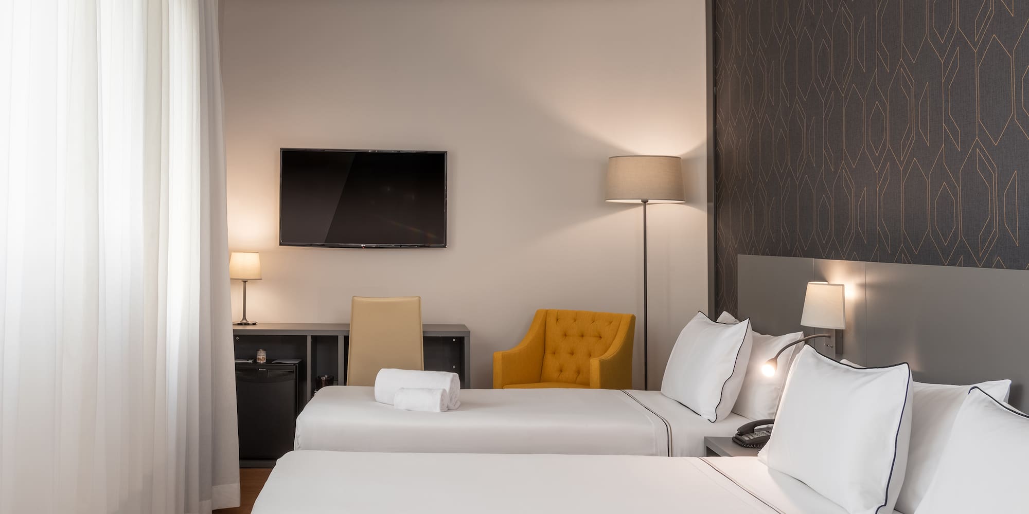 a room with two beds and a tv