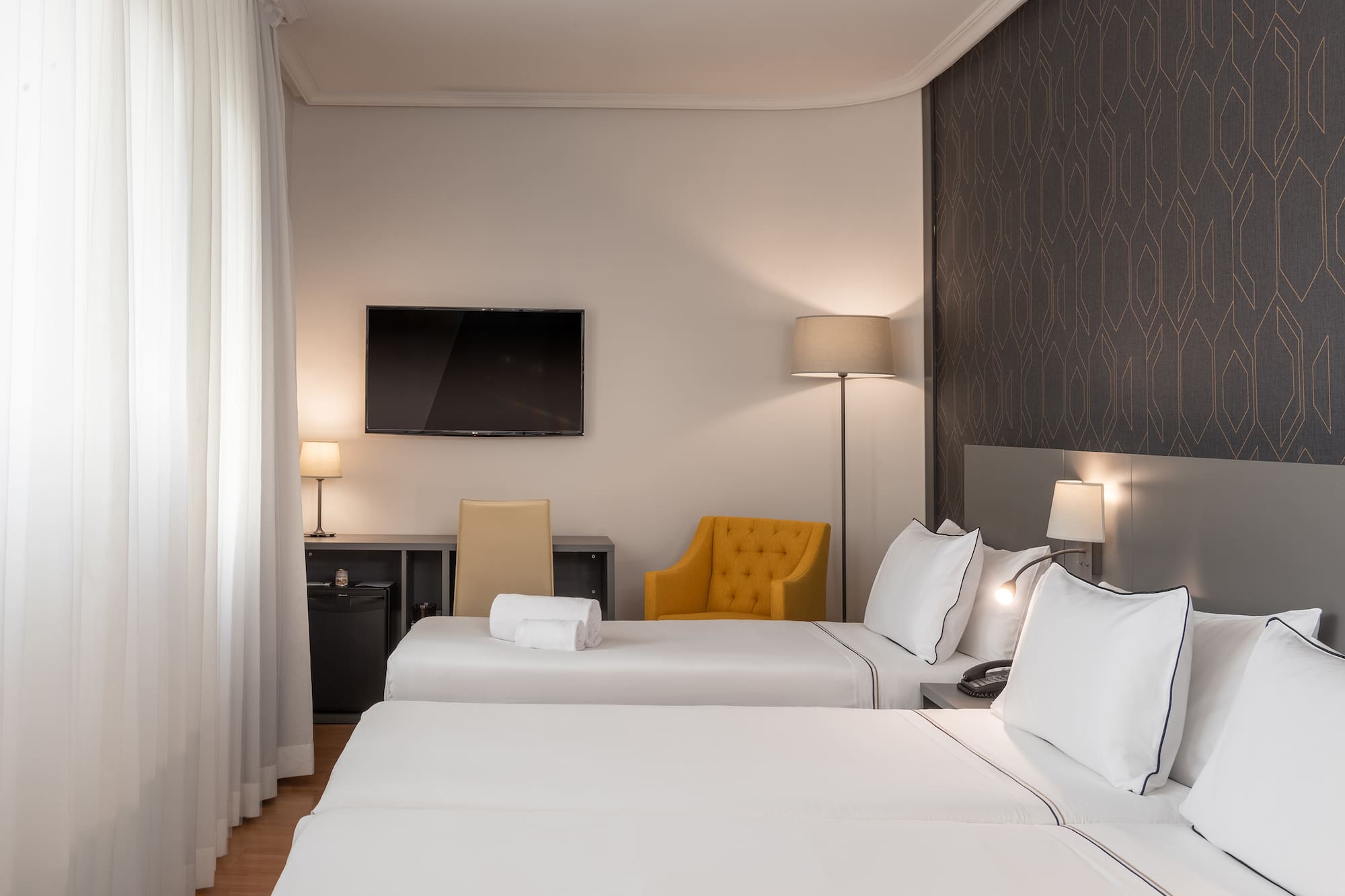 a room with two beds and a tv