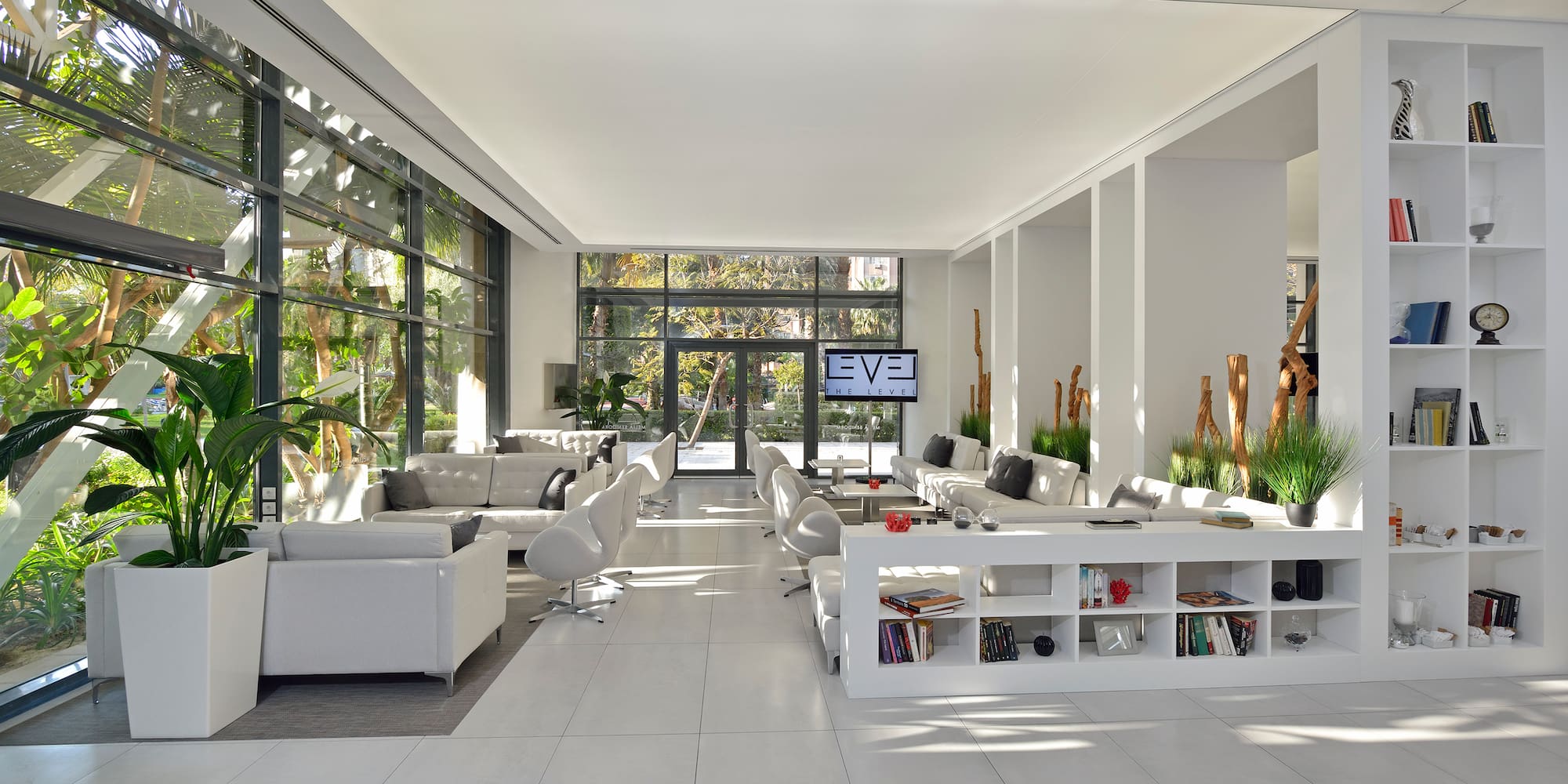 a room with white furniture and a tv