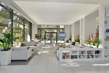 a room with white furniture and a tv