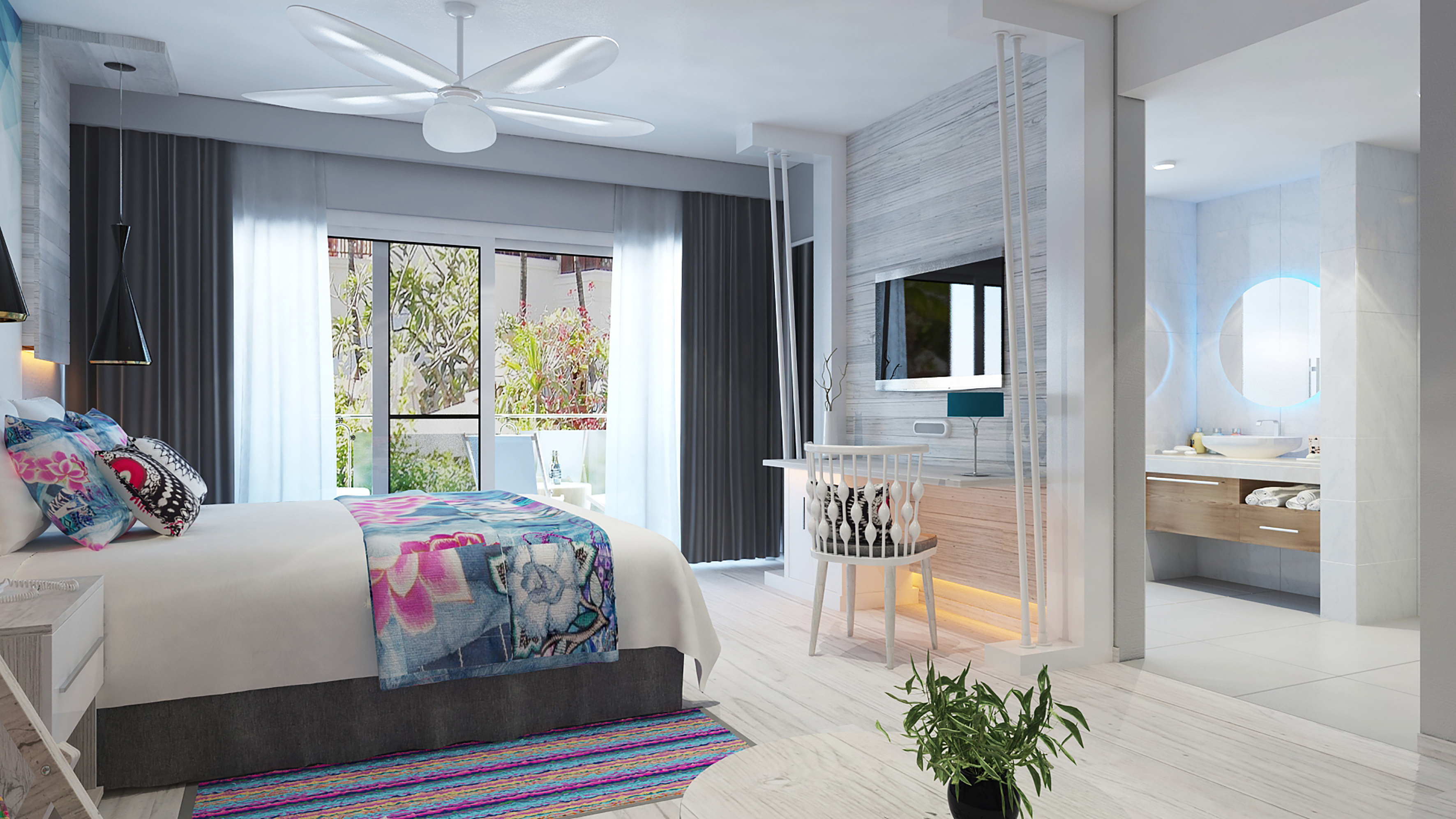 a bedroom with a bed and a sink and a mirror