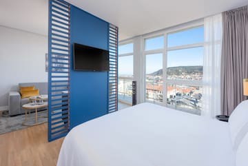 a room with a television and a view of the city