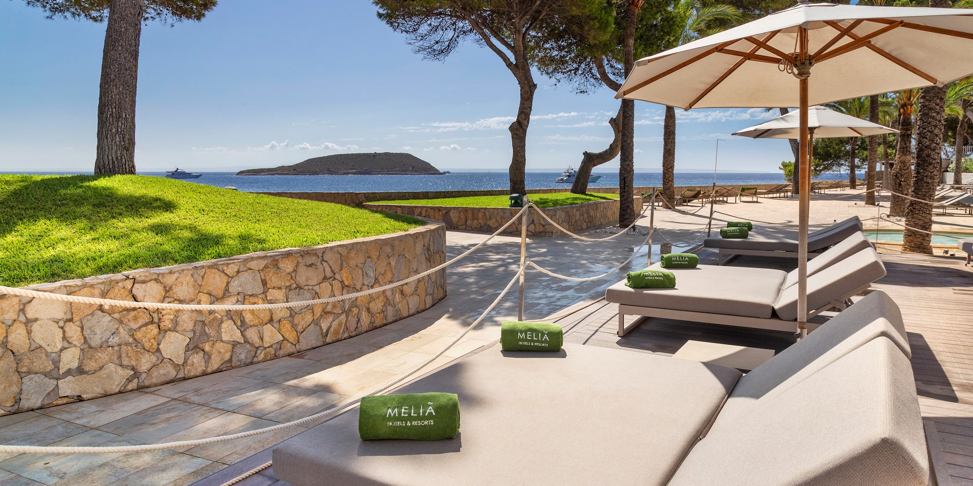 a beach chairs and umbrellas on a patio