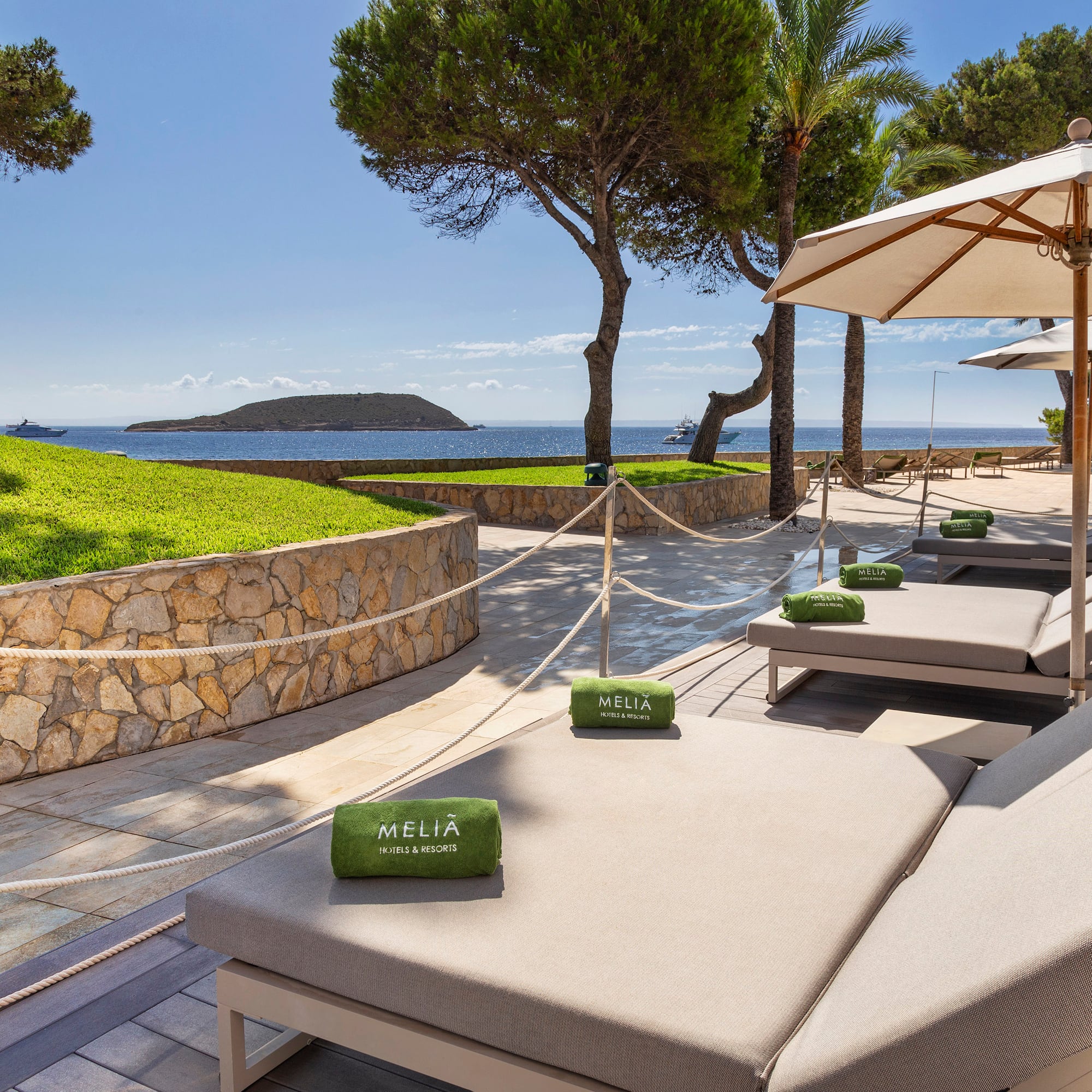 a beach chairs and umbrellas on a patio