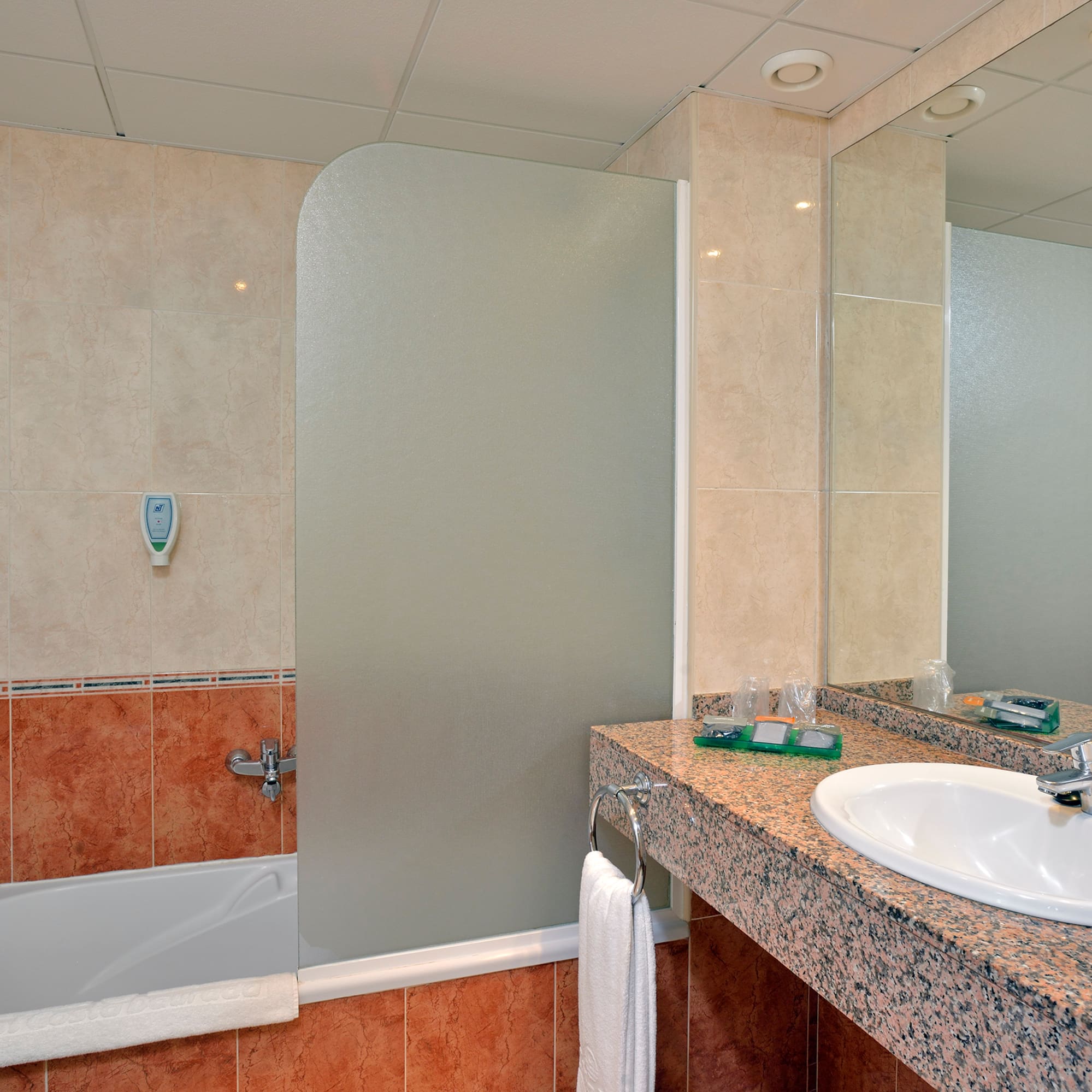 a bathroom with a shower and sink