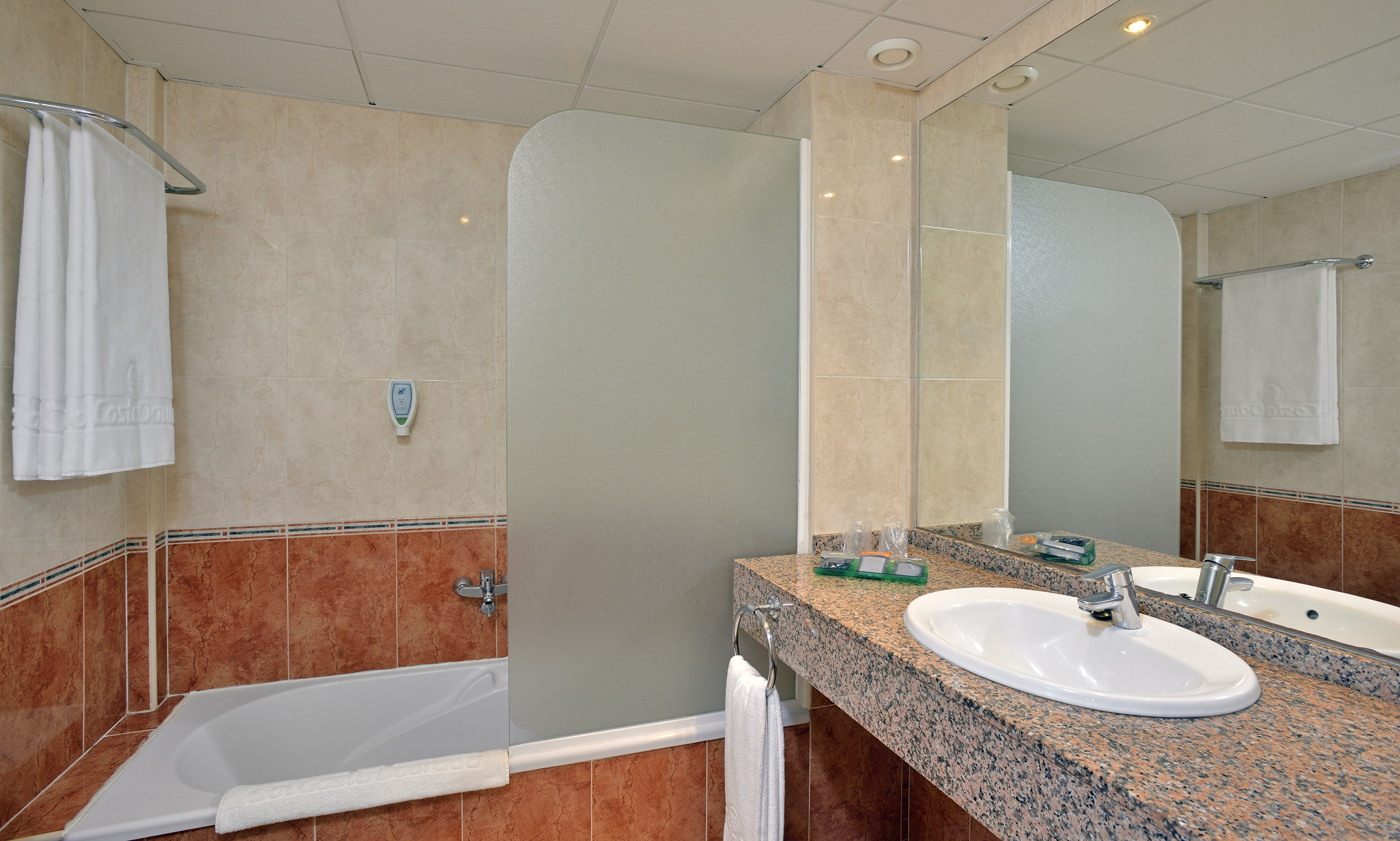 a bathroom with a shower and sink