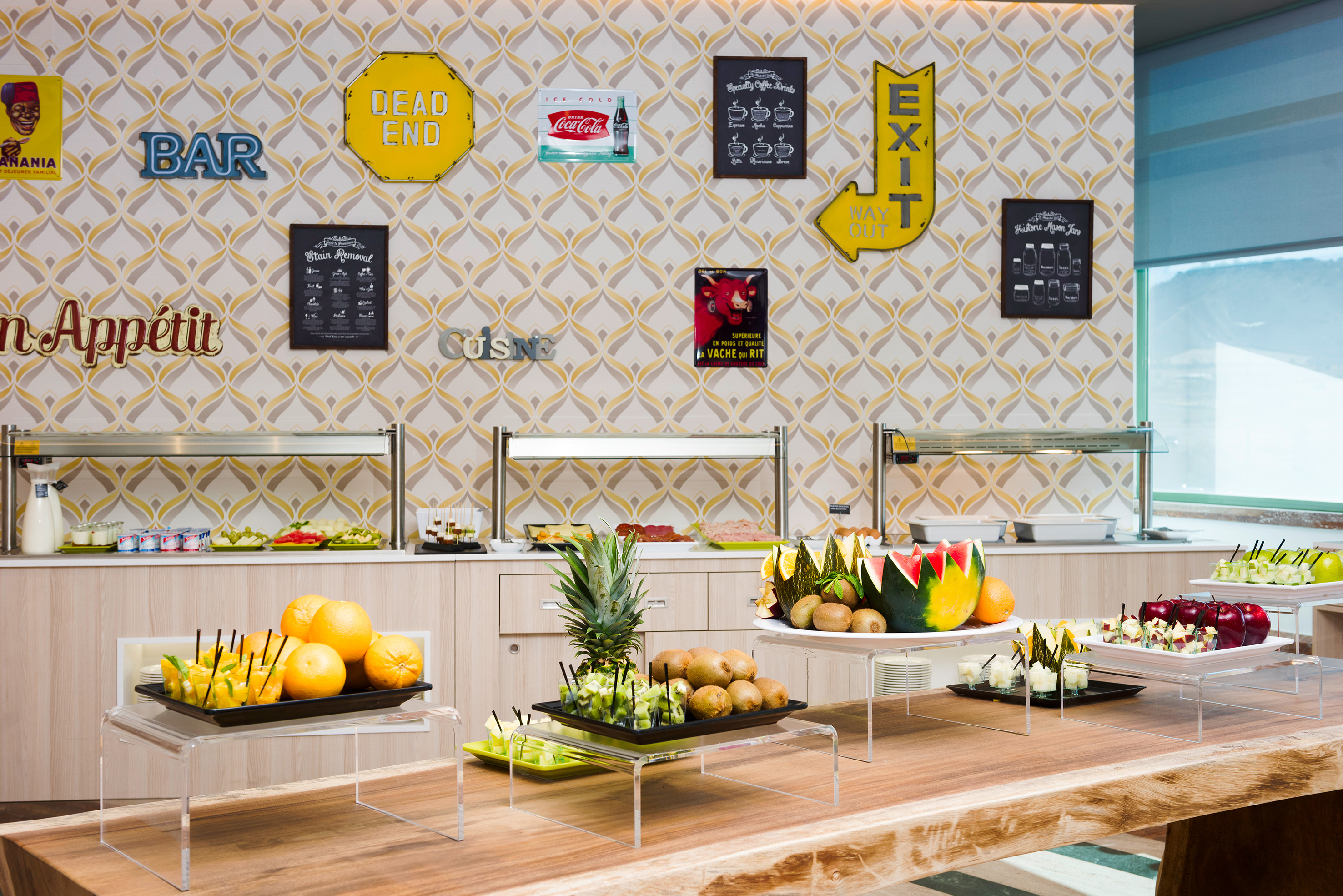 Fresh fruit and healthy food buffet with retro wall signs and decor.