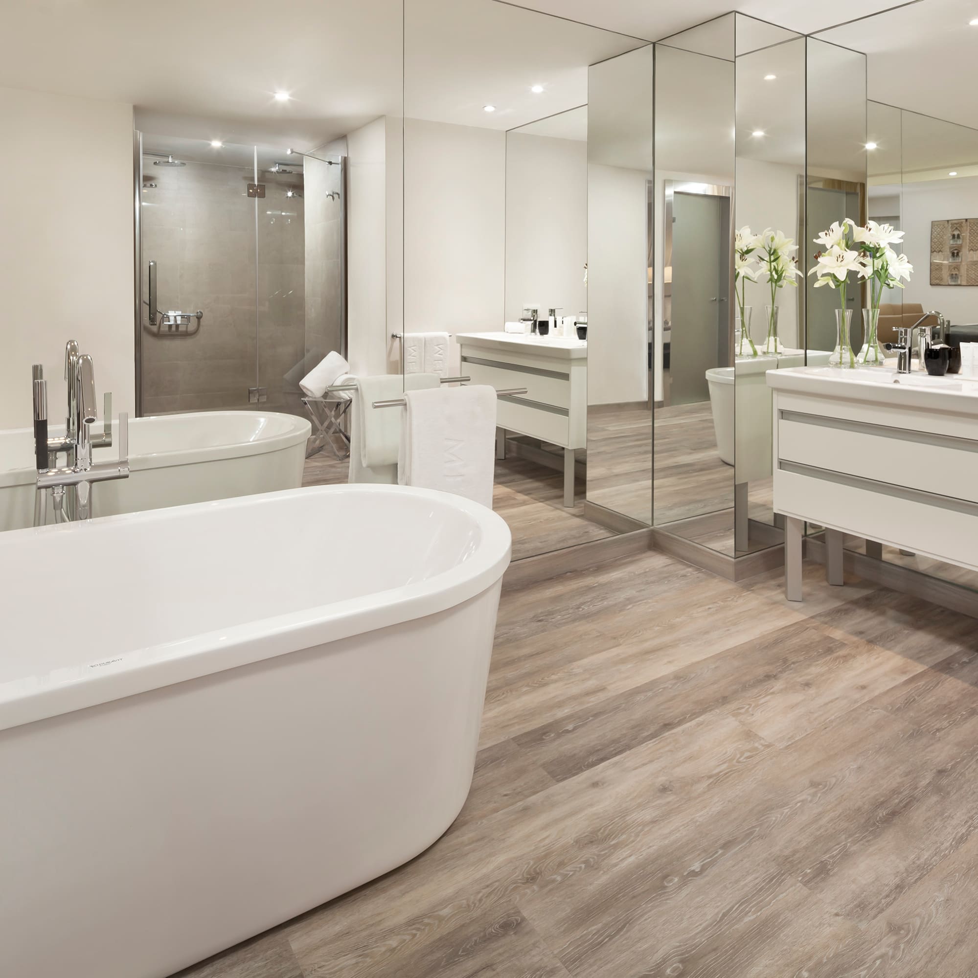 a bathroom with a large tub and a large mirror