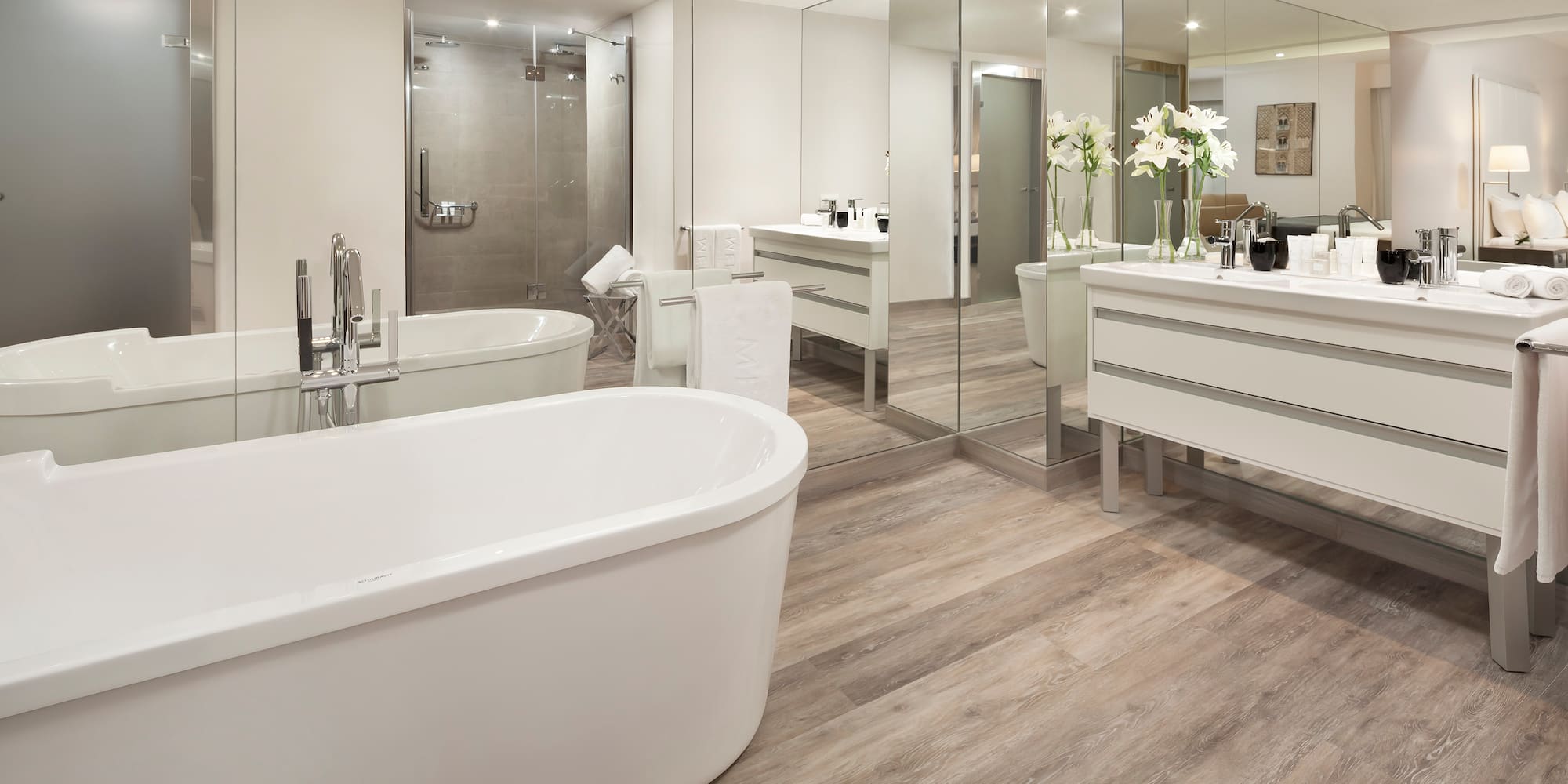 a bathroom with a large tub and a large mirror