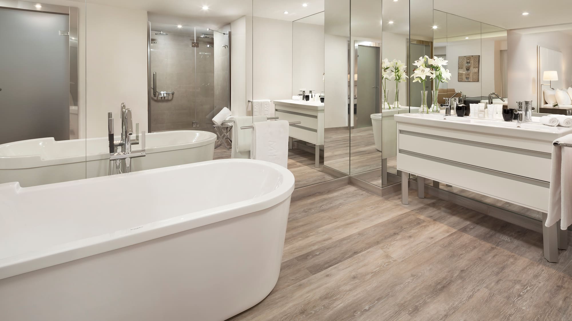 a bathroom with a large tub and a large mirror