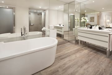a bathroom with a large tub and a large mirror