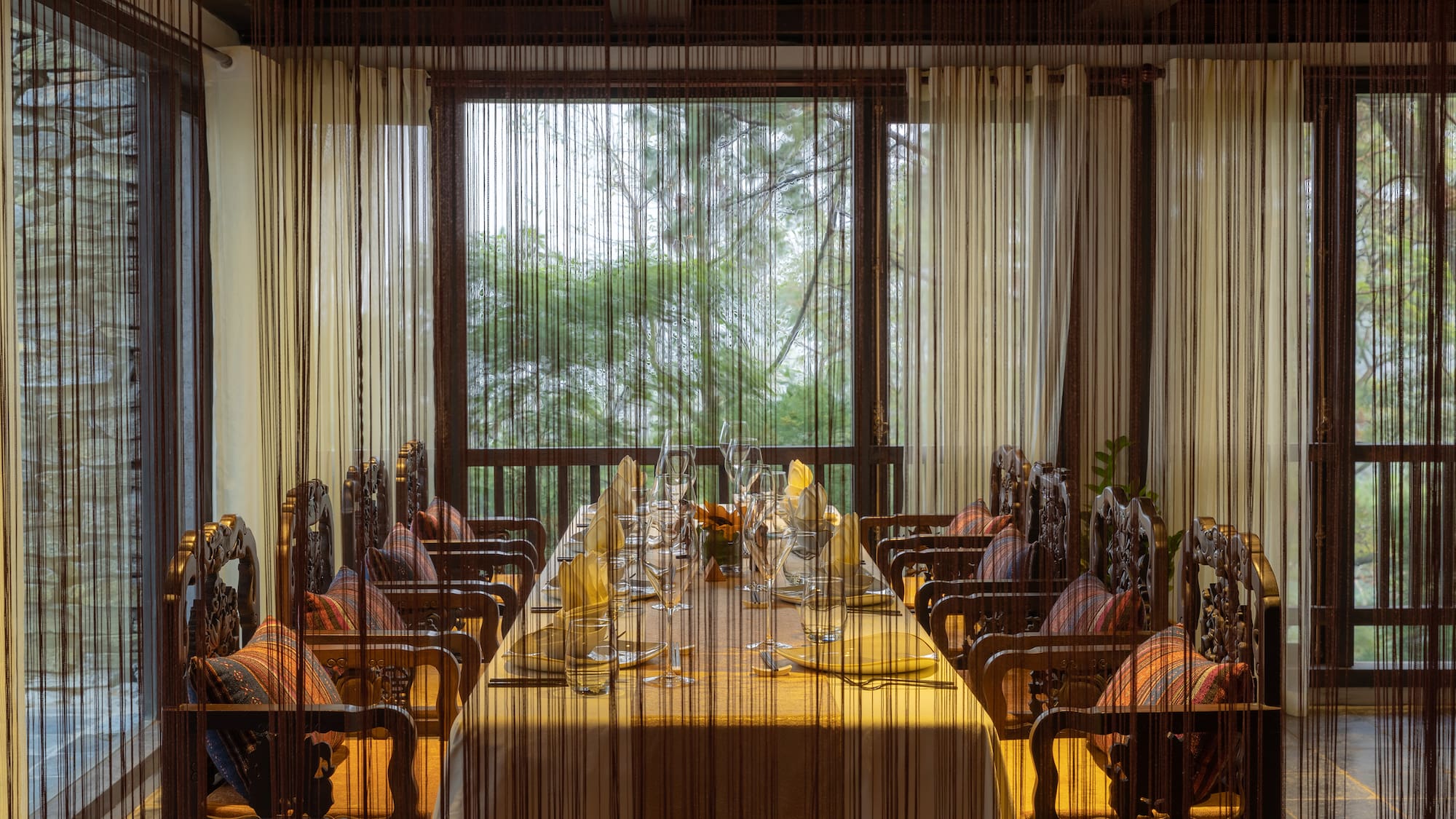 a dining room with a table and chairs