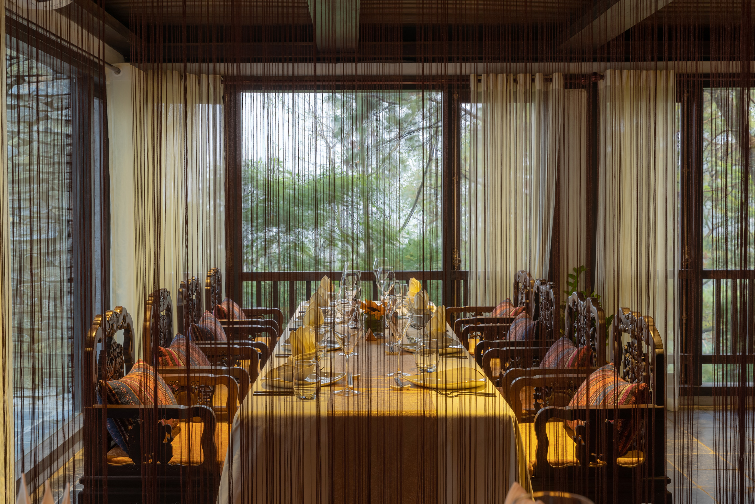 a dining room with a table and chairs