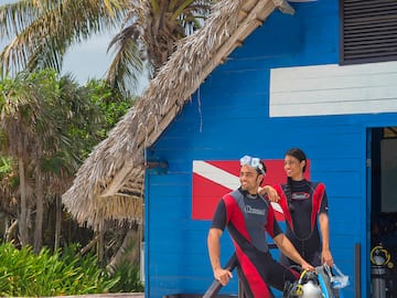 a man and woman standing next to a blue building
