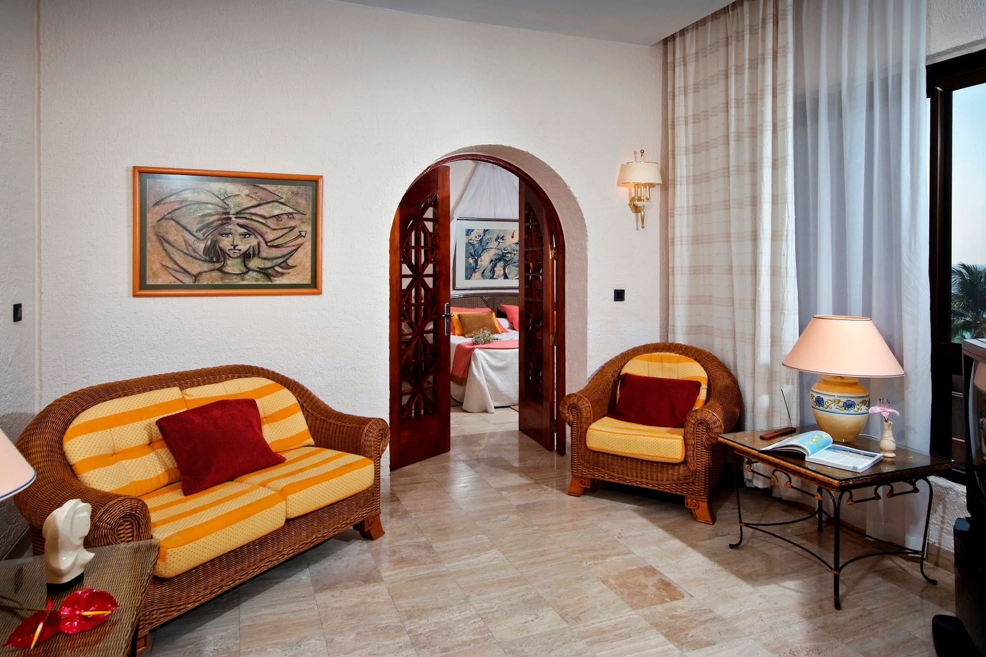 a room with a couch and chairs