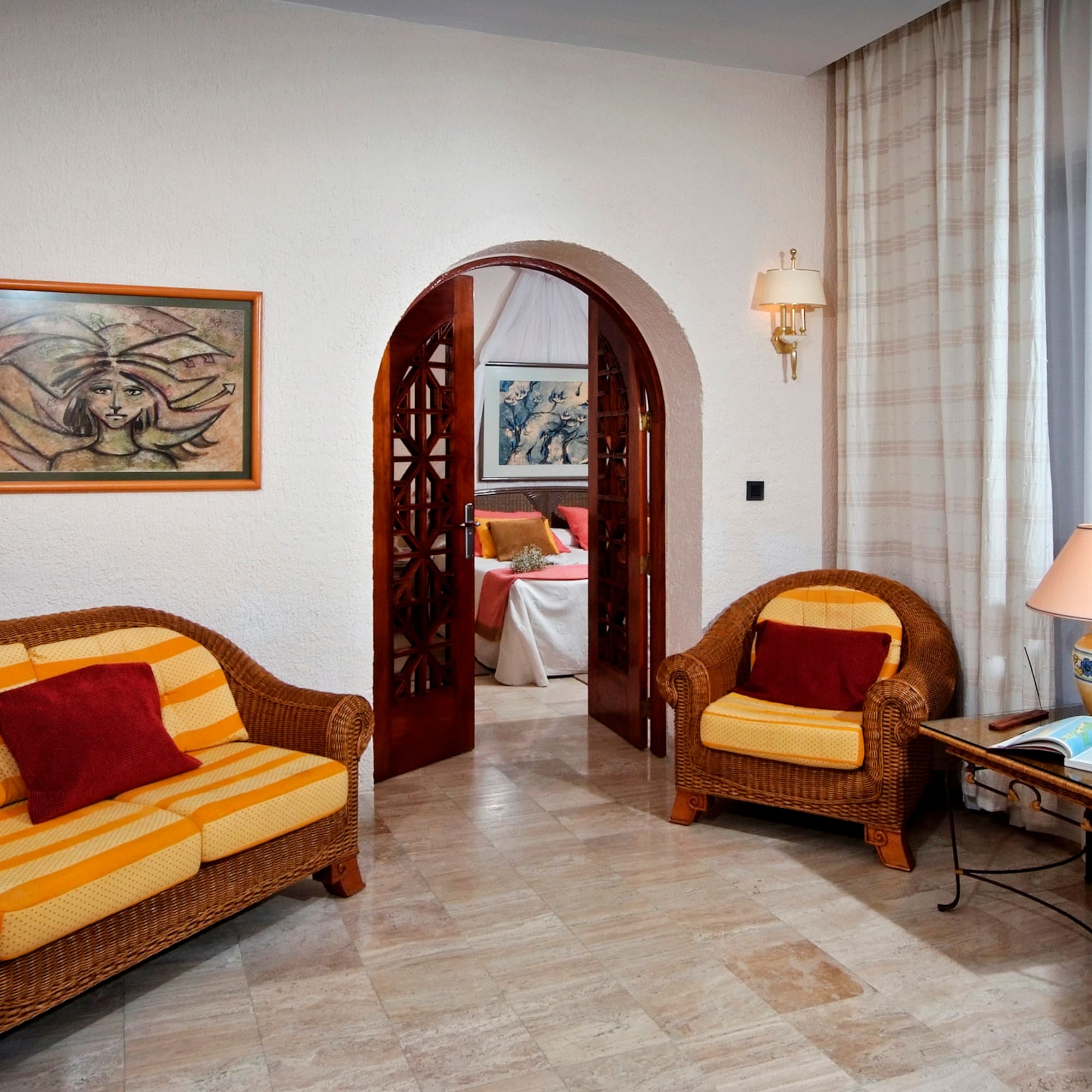 a room with a couch and chairs