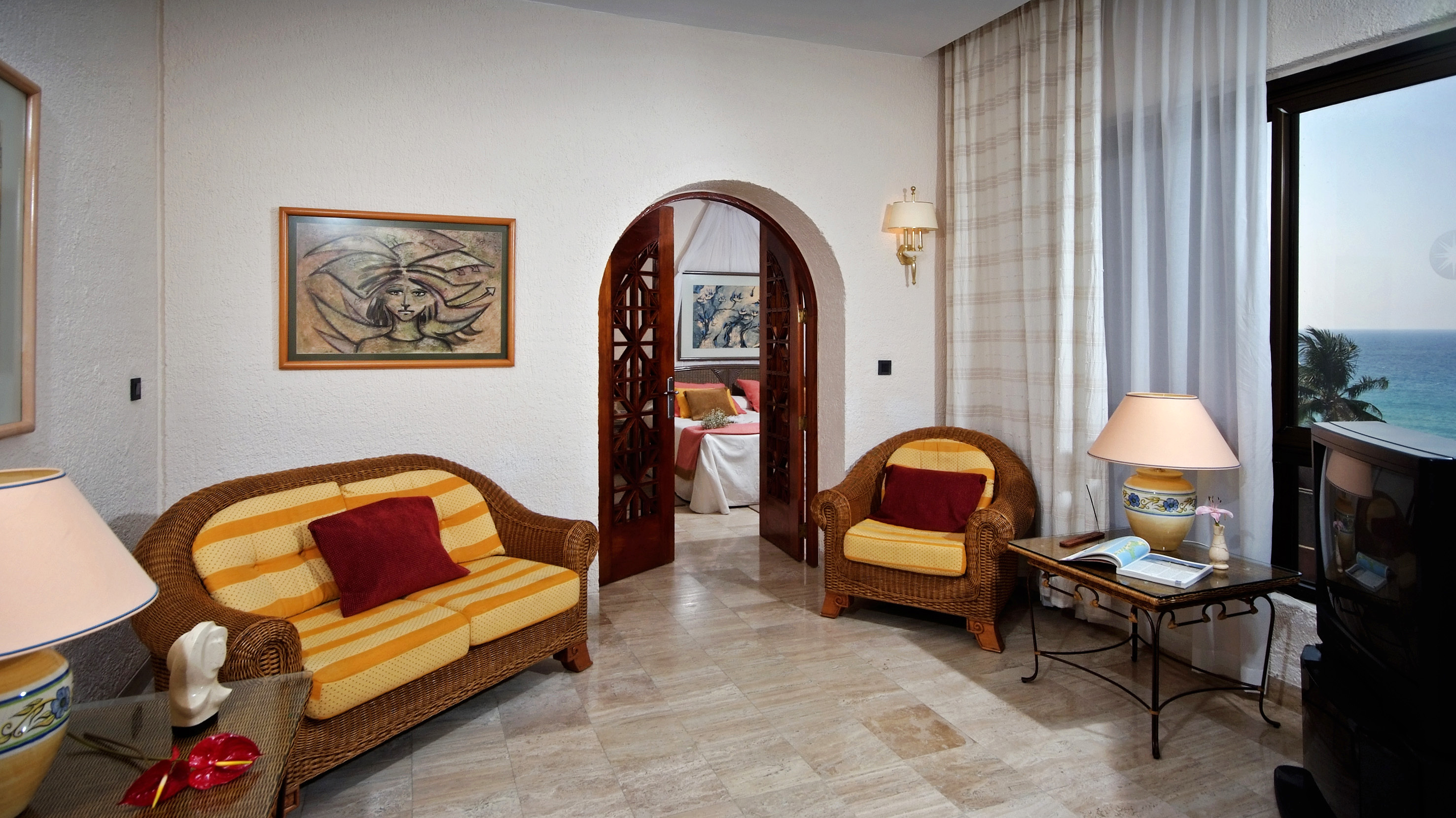 a room with a couch and chairs