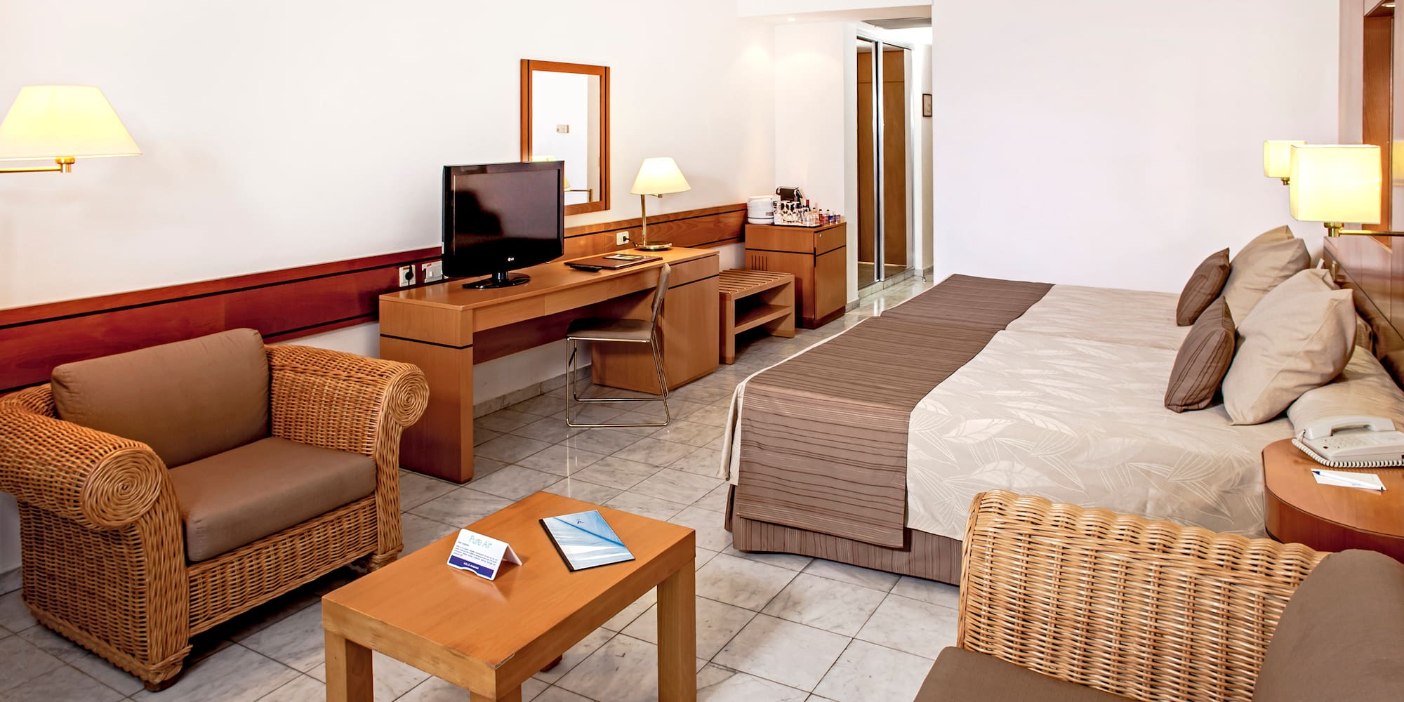 a room with a bed and a television