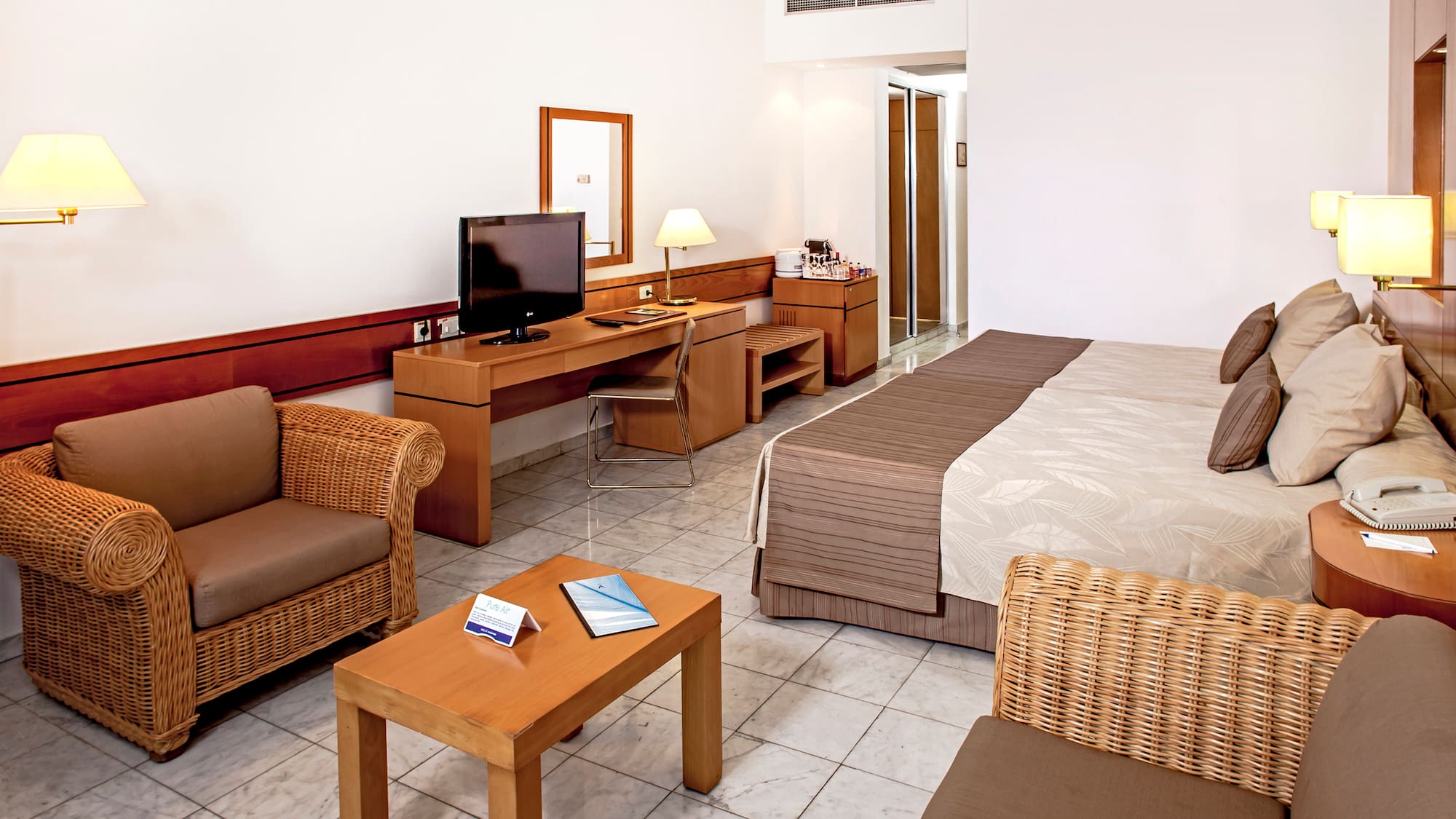 a room with a bed and a television