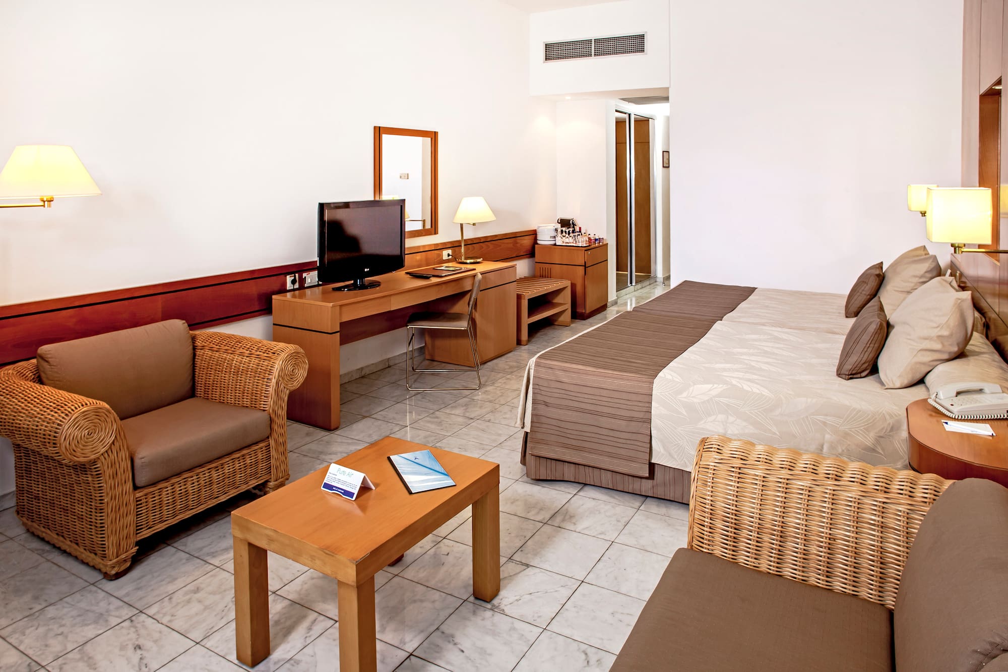 a room with a bed and a television