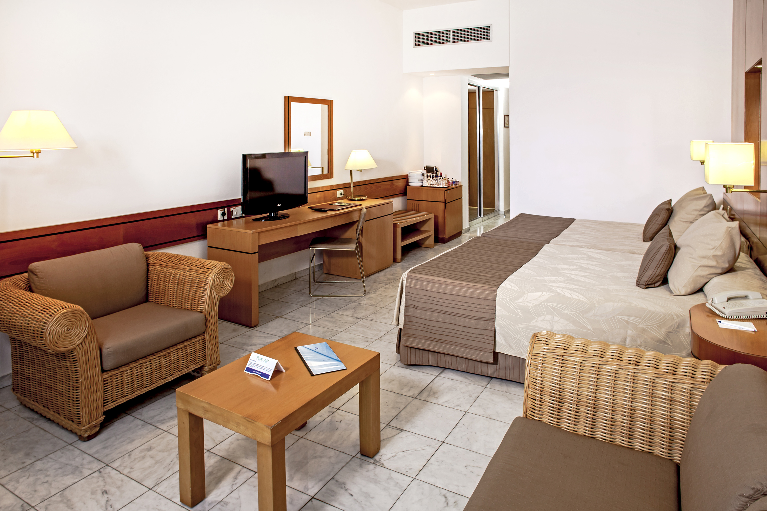 a room with a bed and a television