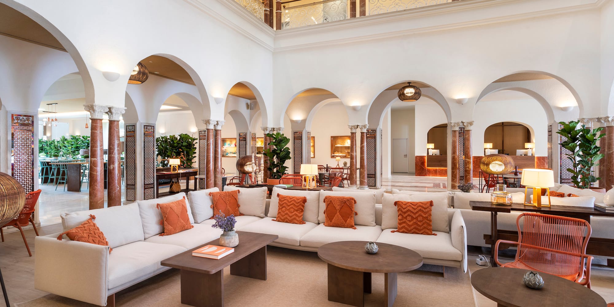 a large room with white couches and tables
