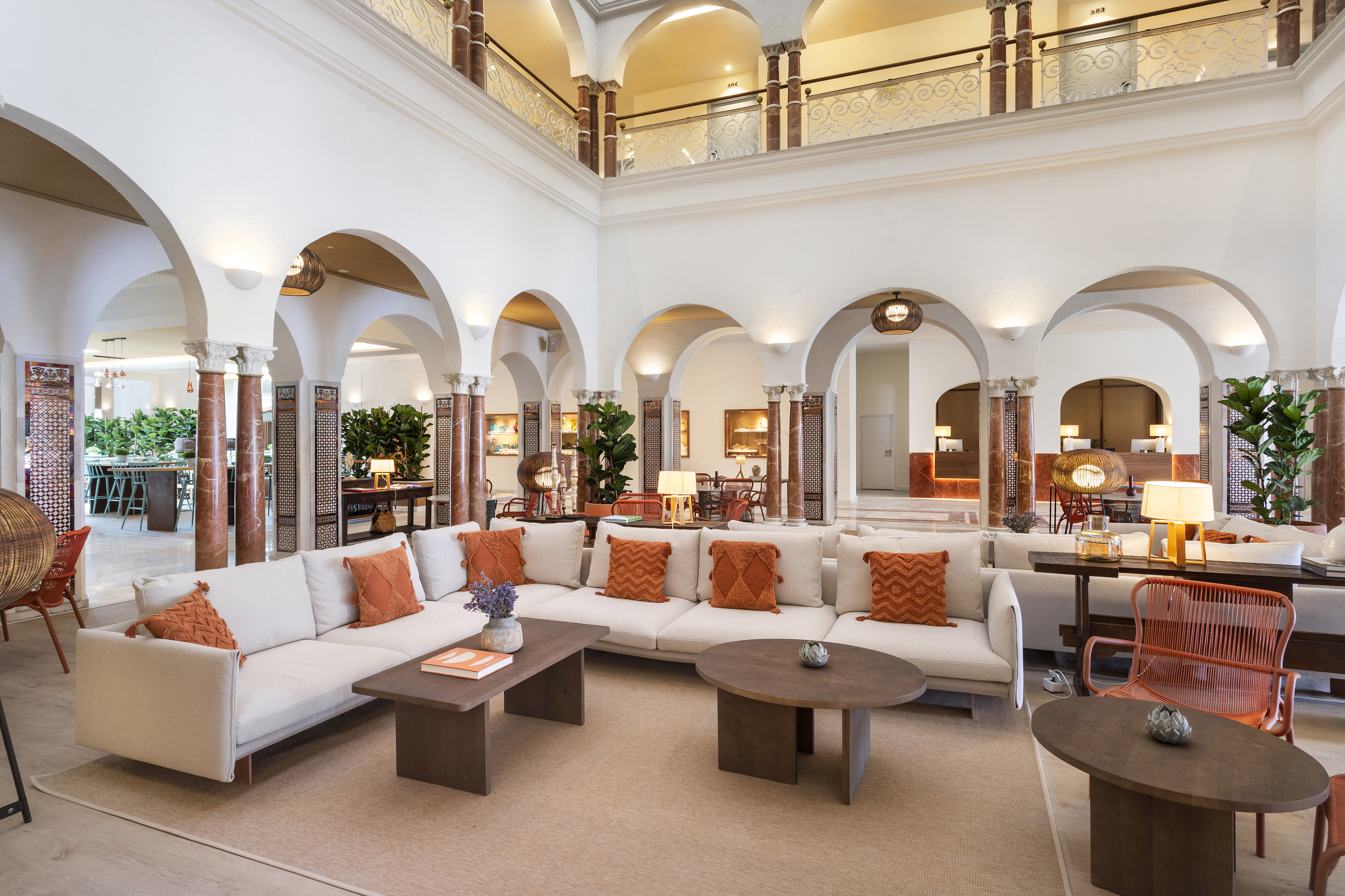 a large room with white couches and tables
