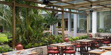 a patio with tables and chairs