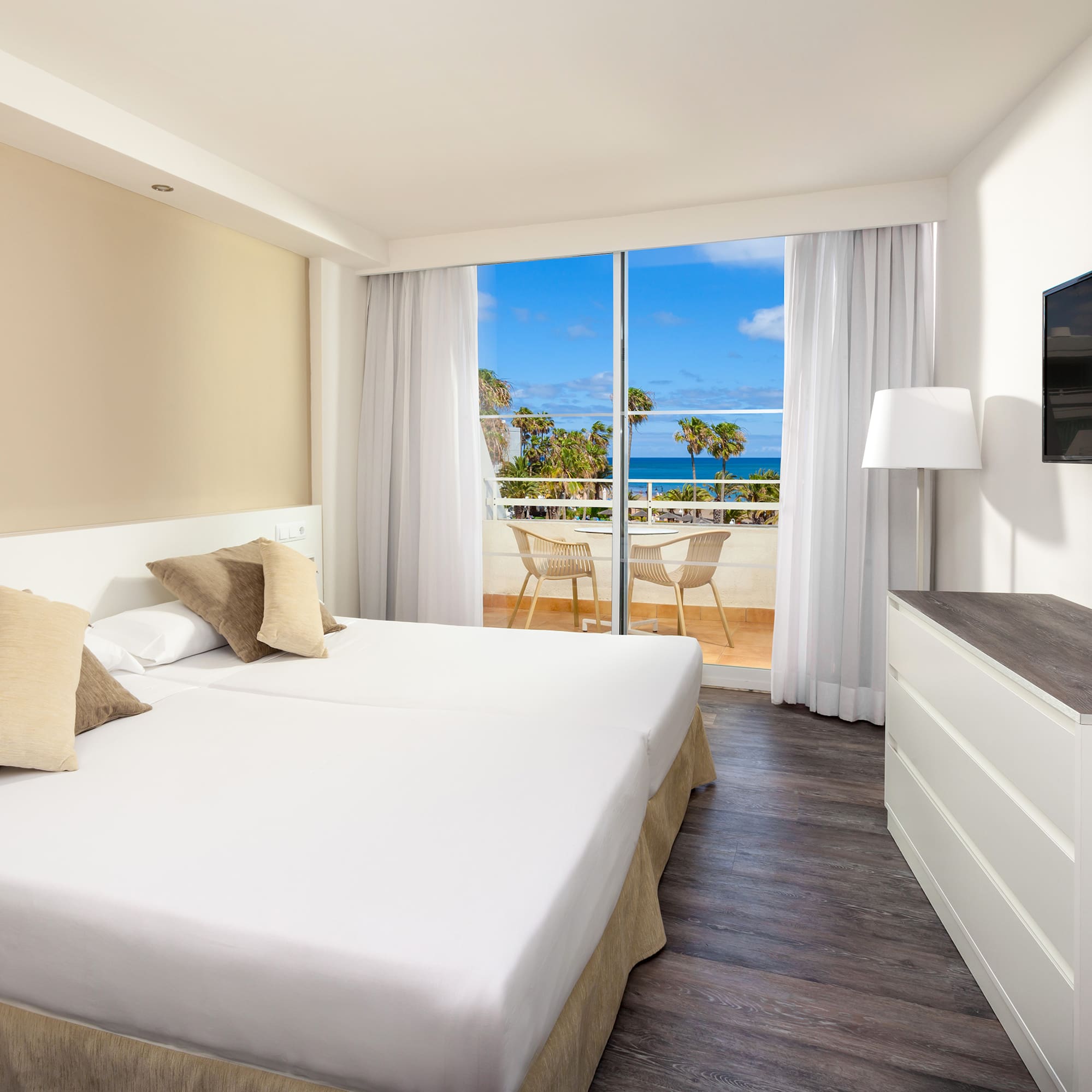 a room with a large bed and a television