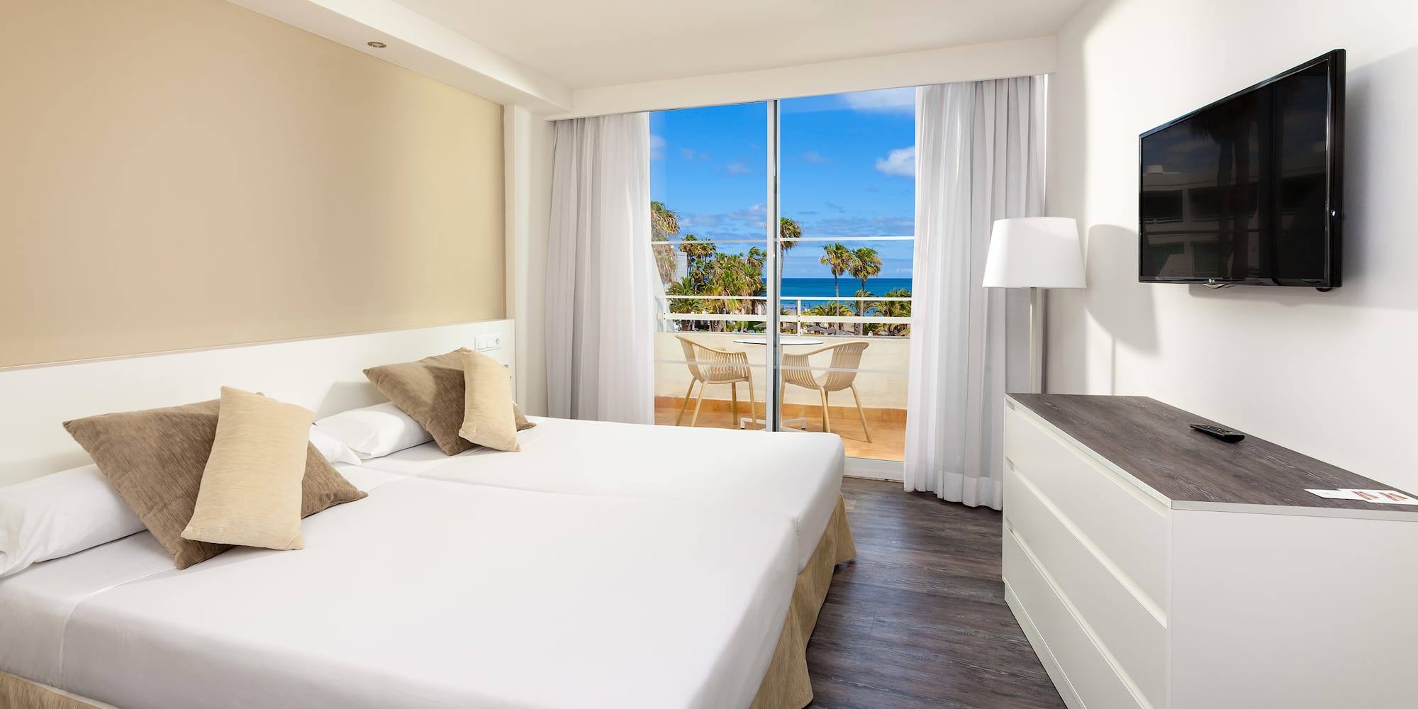 a room with a large bed and a television