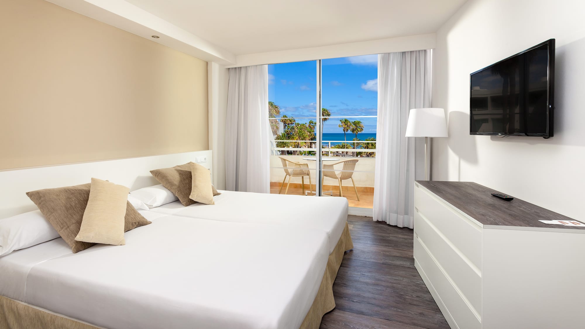 a room with a large bed and a television