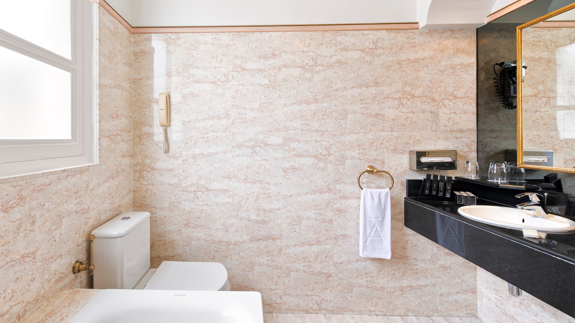 a bathroom with a sink toilet and toilet