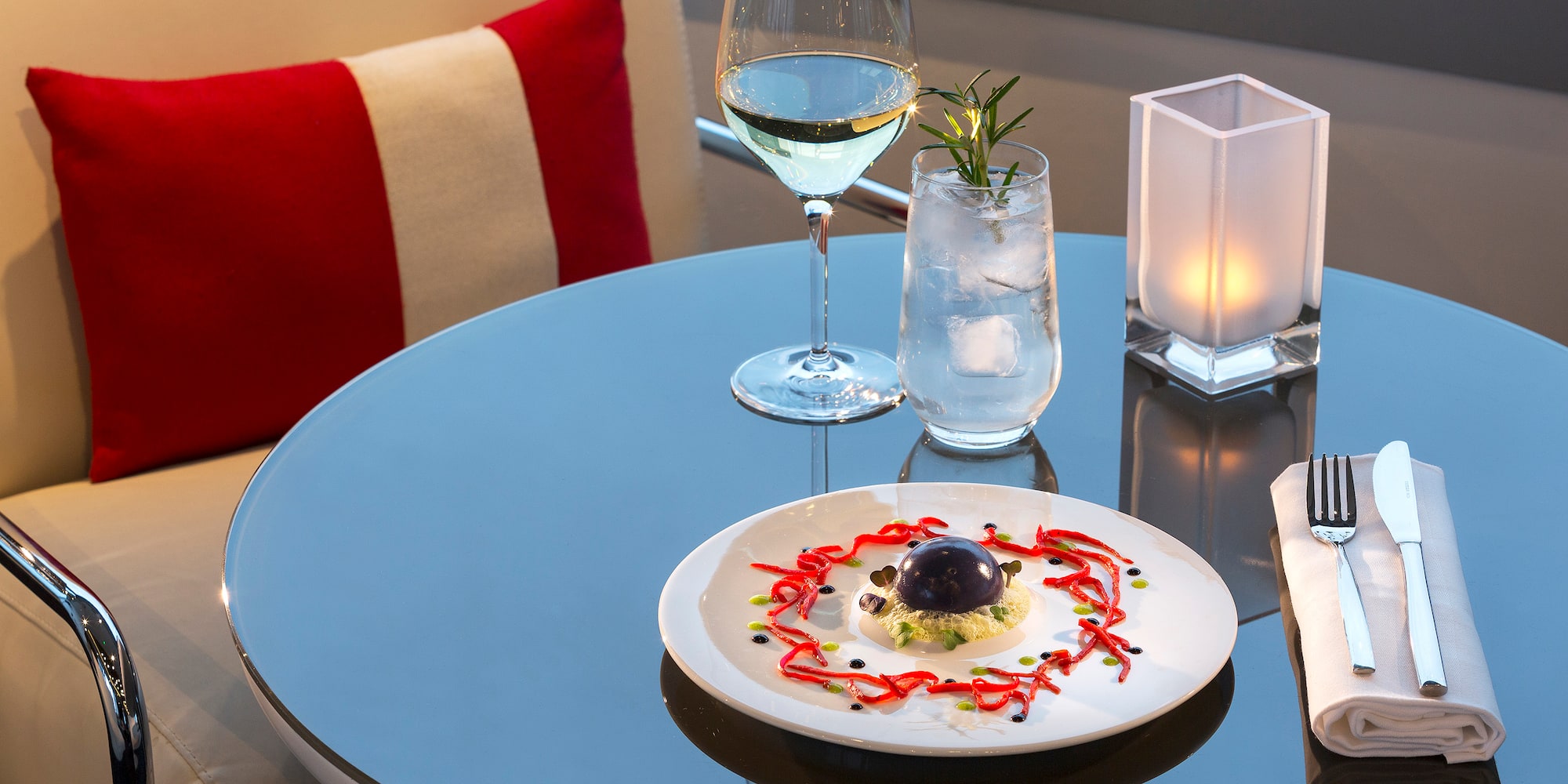 a plate of food and a glass of wine on a table