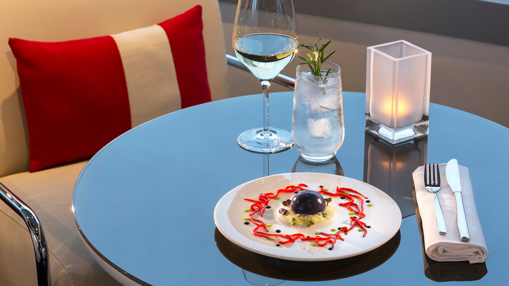 a plate of food and a glass of wine on a table