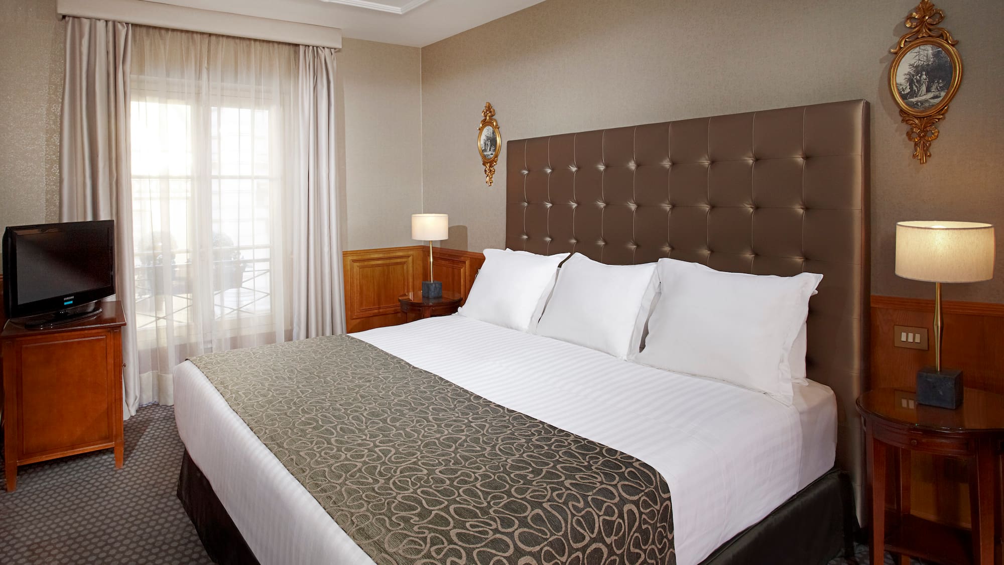 a bed with pillows and a lamp in a room