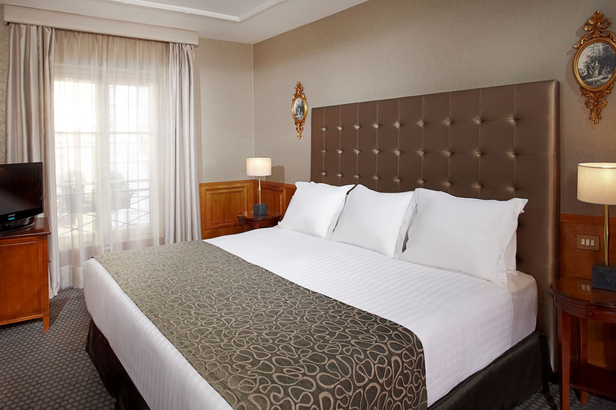 a bed with pillows and a lamp in a room