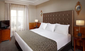 a bed with pillows and a lamp in a room