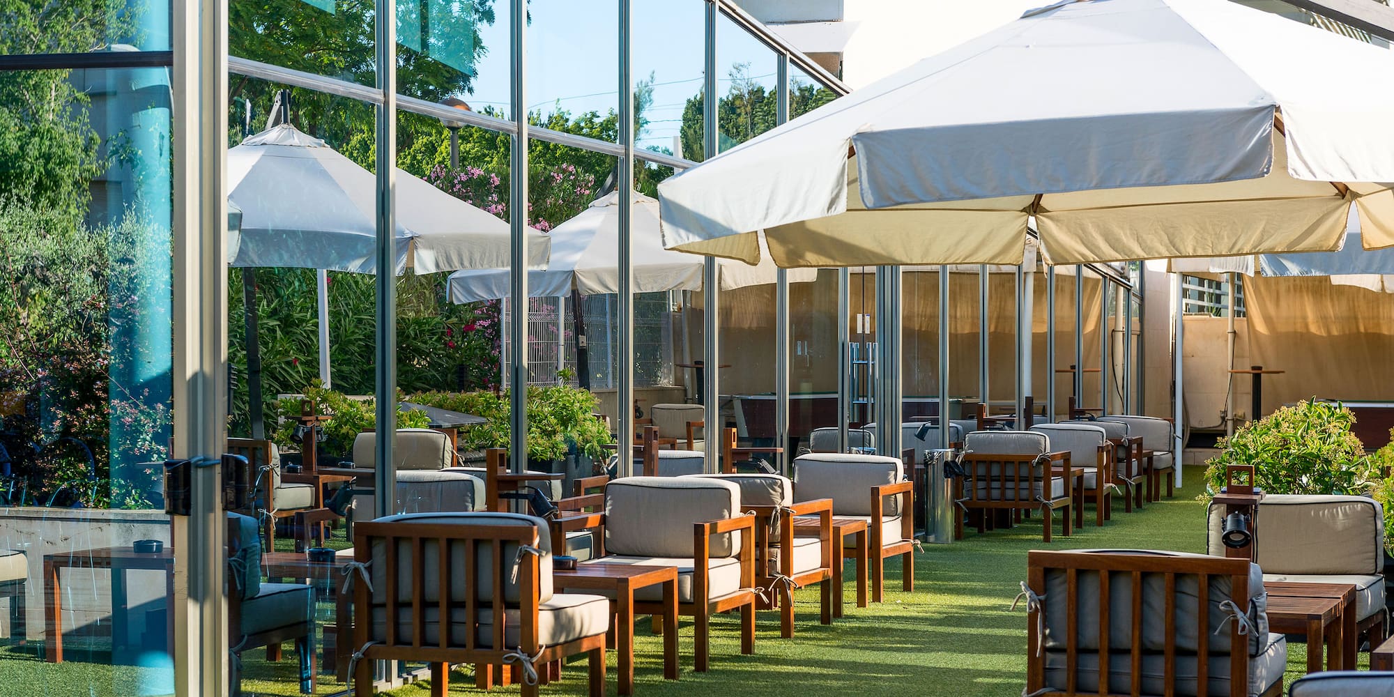 a patio area with chairs and umbrellas