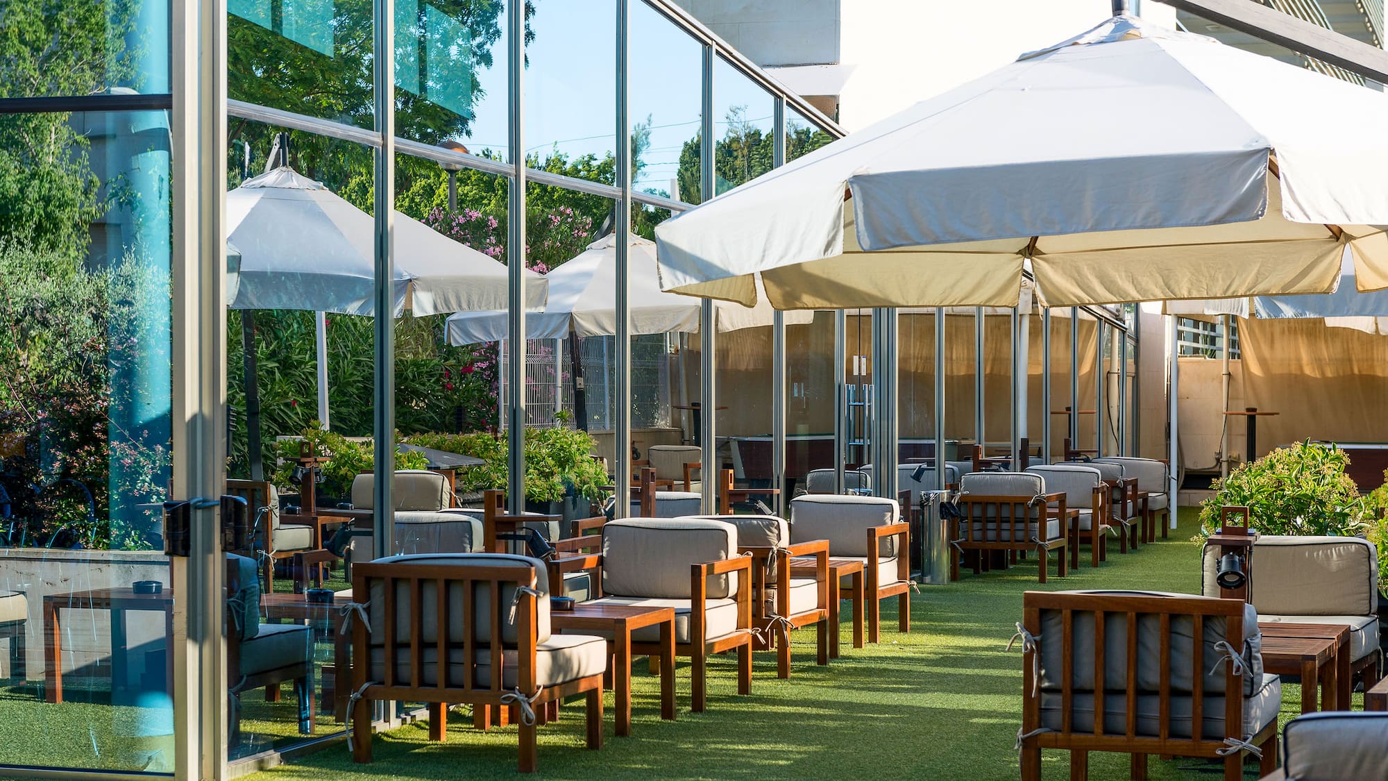 a patio area with chairs and umbrellas