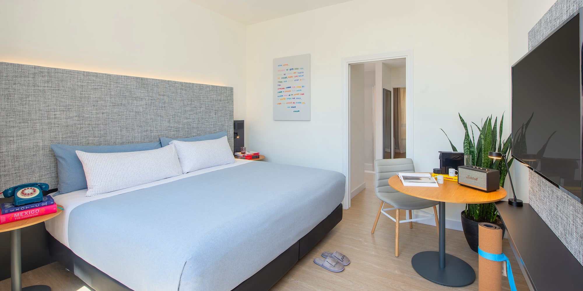 a bedroom with a bed and a table