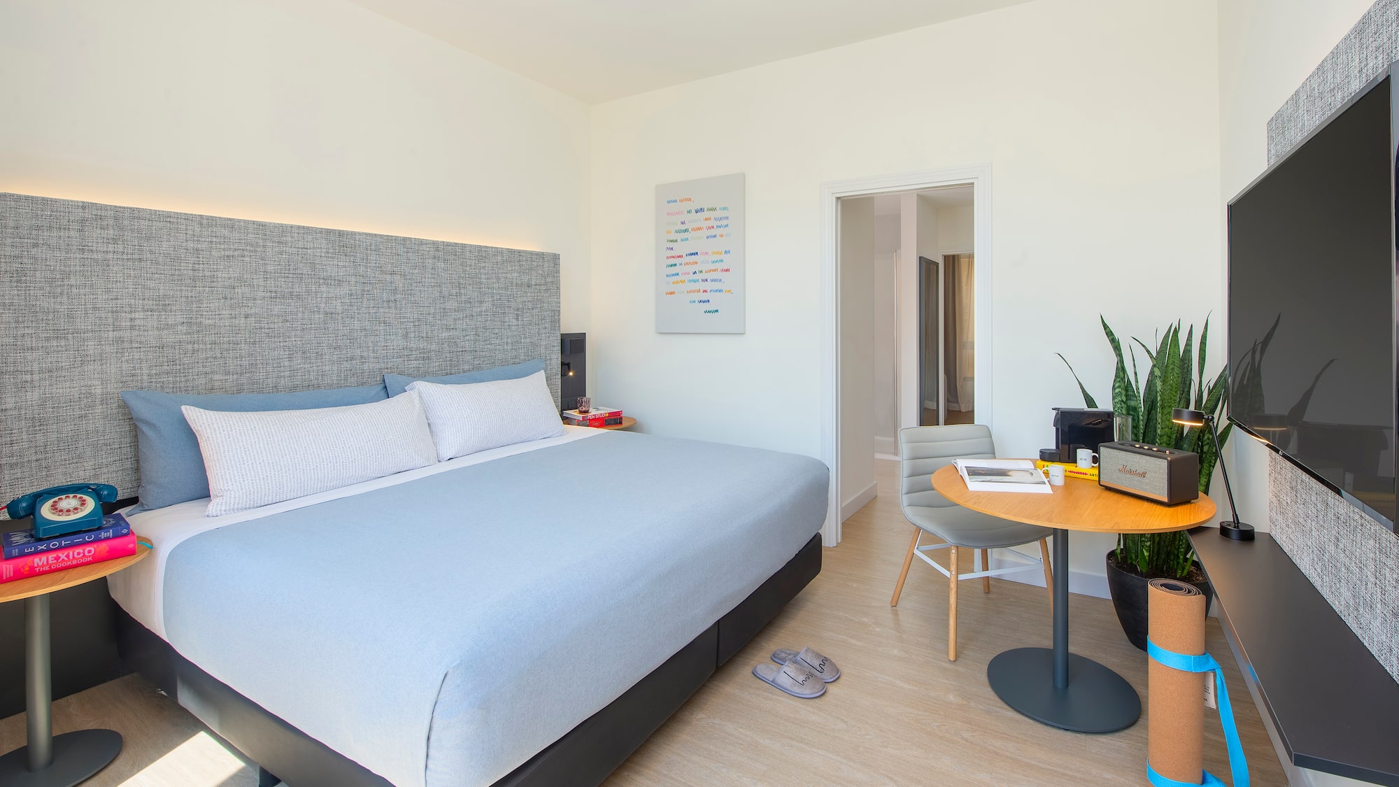 a bedroom with a bed and a table