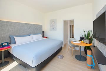 a bedroom with a bed and a table