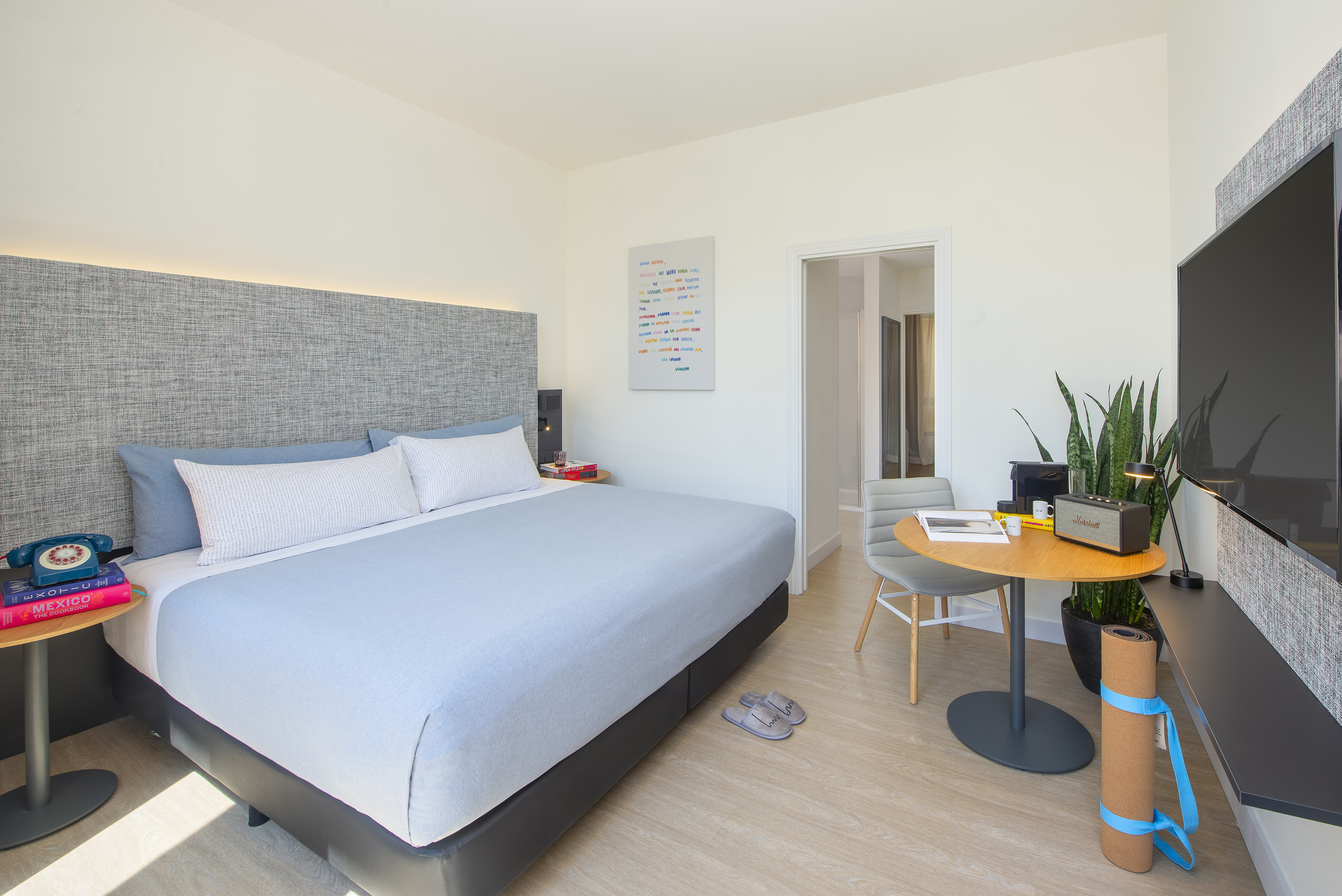 a bedroom with a bed and a table